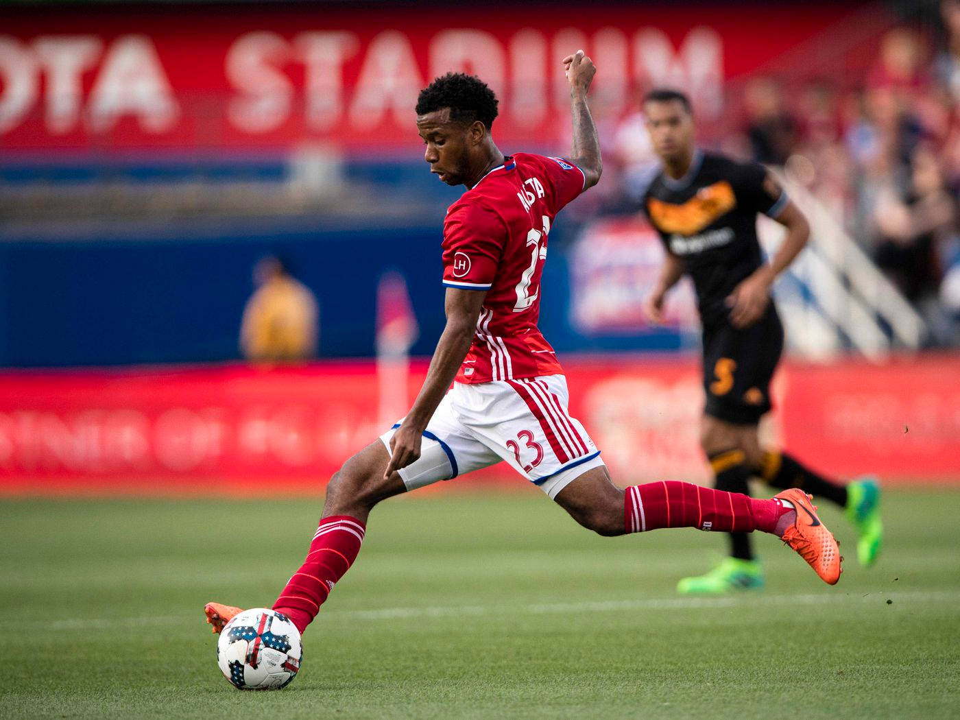 Kellyn Acosta Kicking Ball Fc Dallas Background