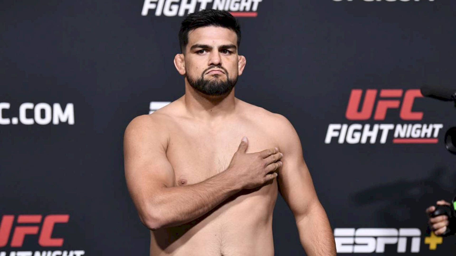 Kelvin Gastelum, Secure And Focused In The Cage Background