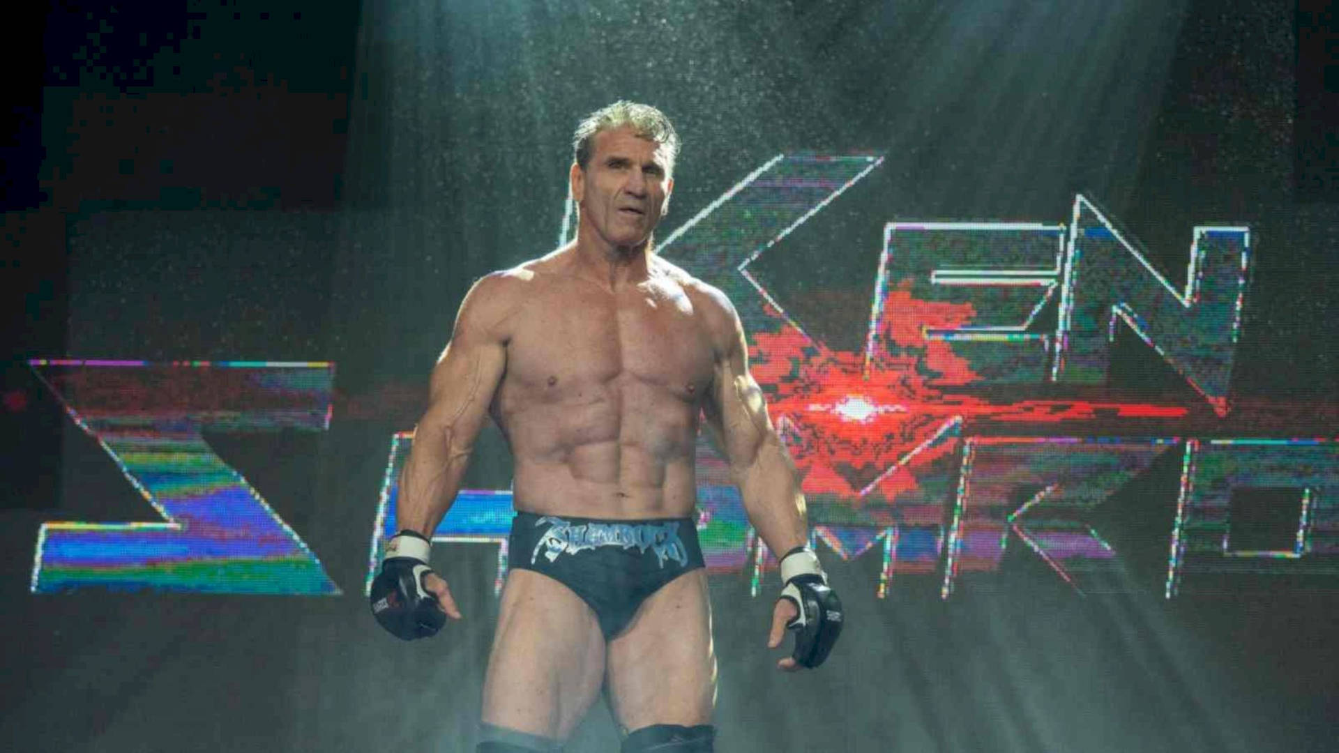 Ken Shamrock Under The Spotlight Background