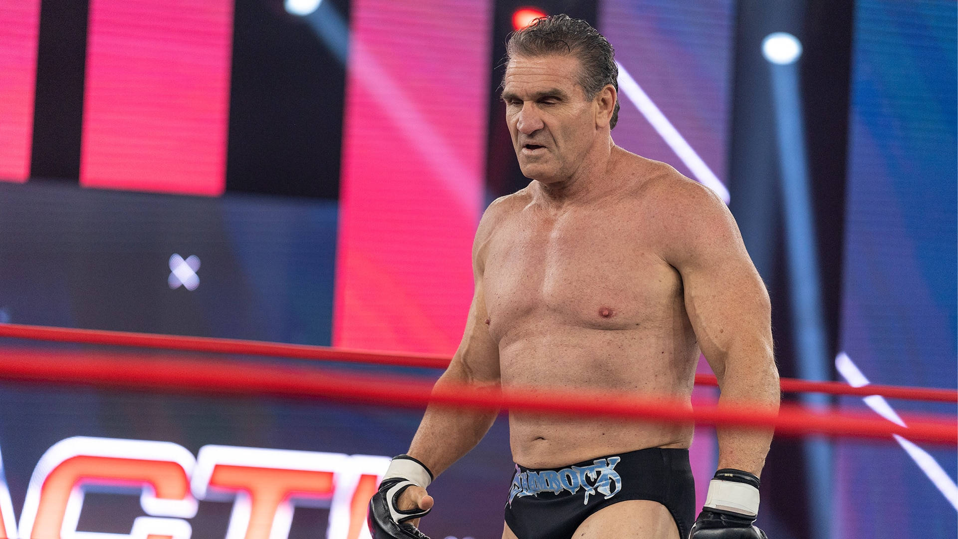 Ken Shamrock Walking Inside Ring Background