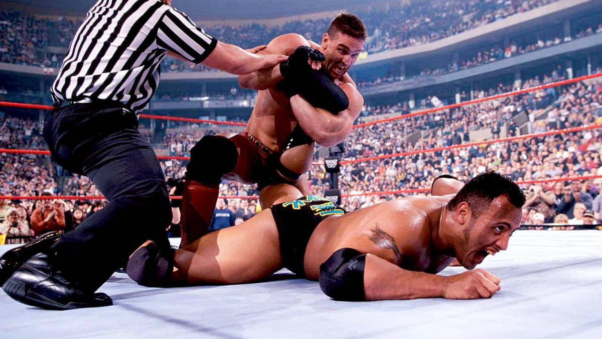 Ken Shamrock Winning Against The Rock Background