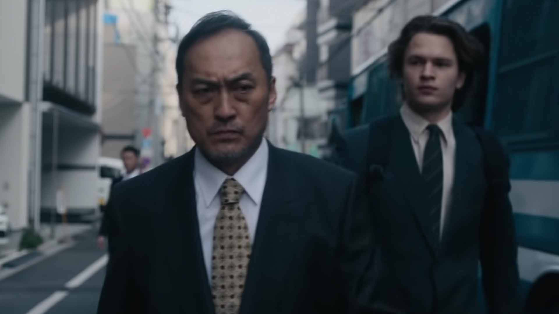 Ken Watanabe And Ansel Elgort In A Riveting Scene From The Movie, Tokyo Vice. Background