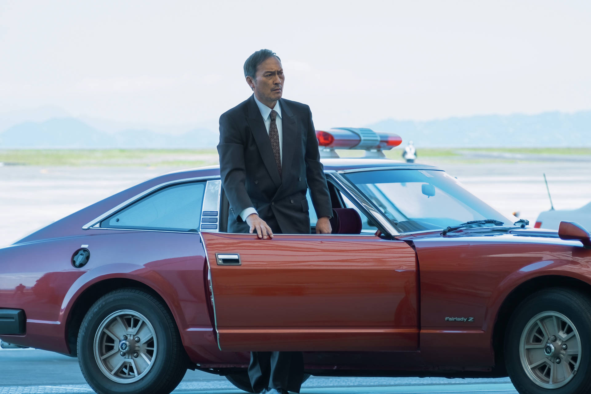 Ken Watanabe With Nissan Fairlady Z From Tokyo Vice Background