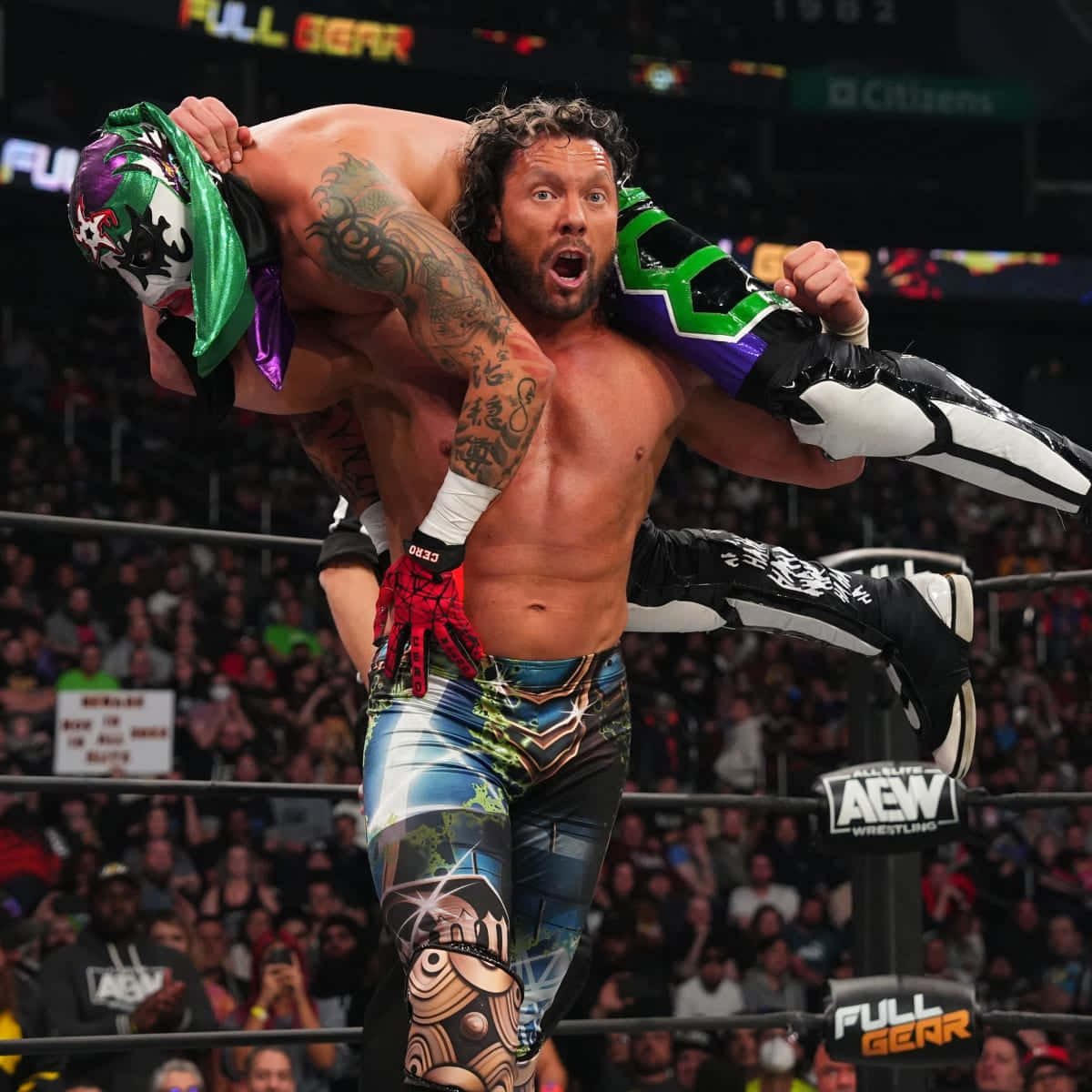 Kenny Omega Carrying Pentagón Jr Background