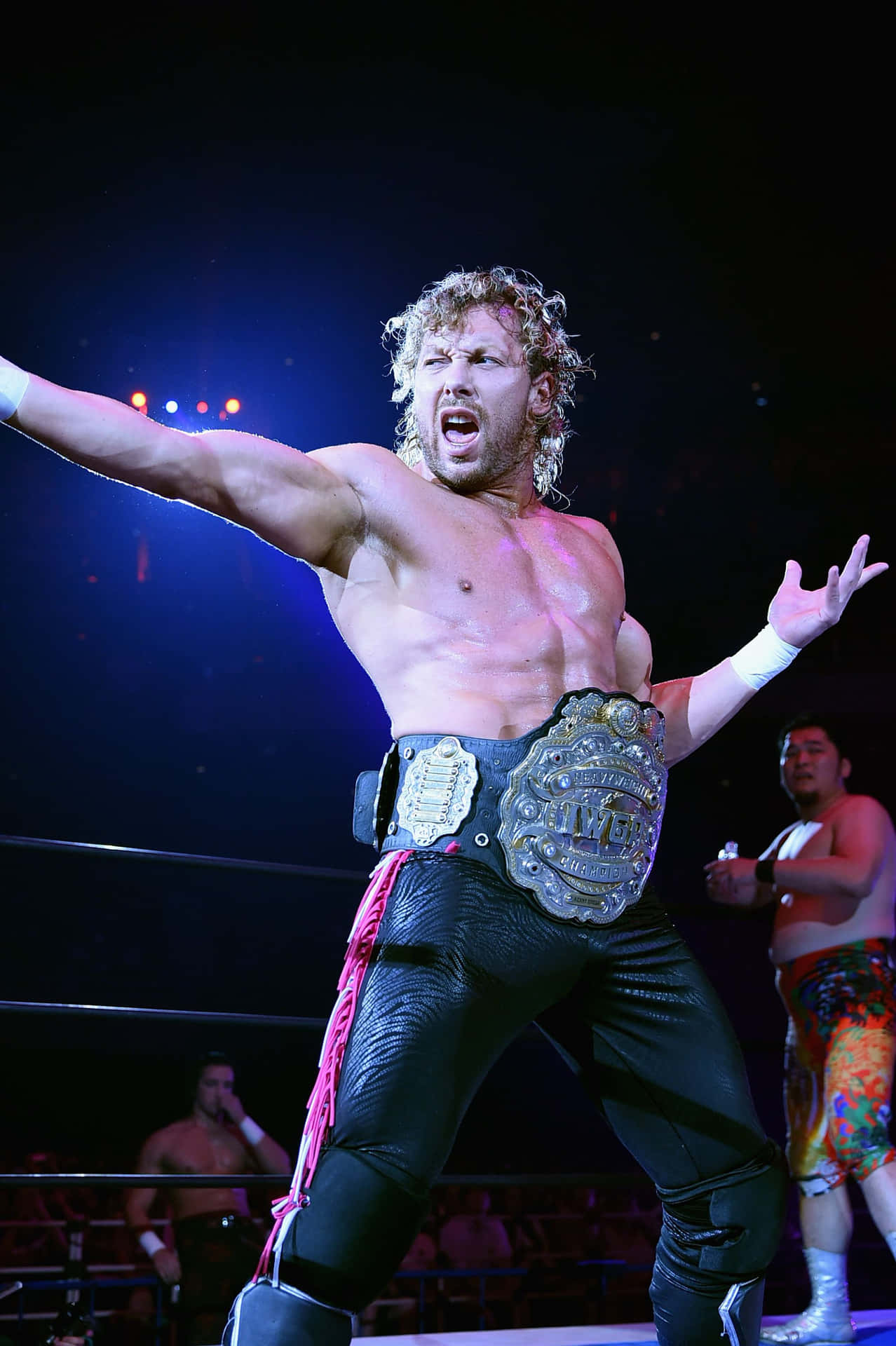 Kenny Omega Holding The Iwgp Heavyweight Championship Belt Background