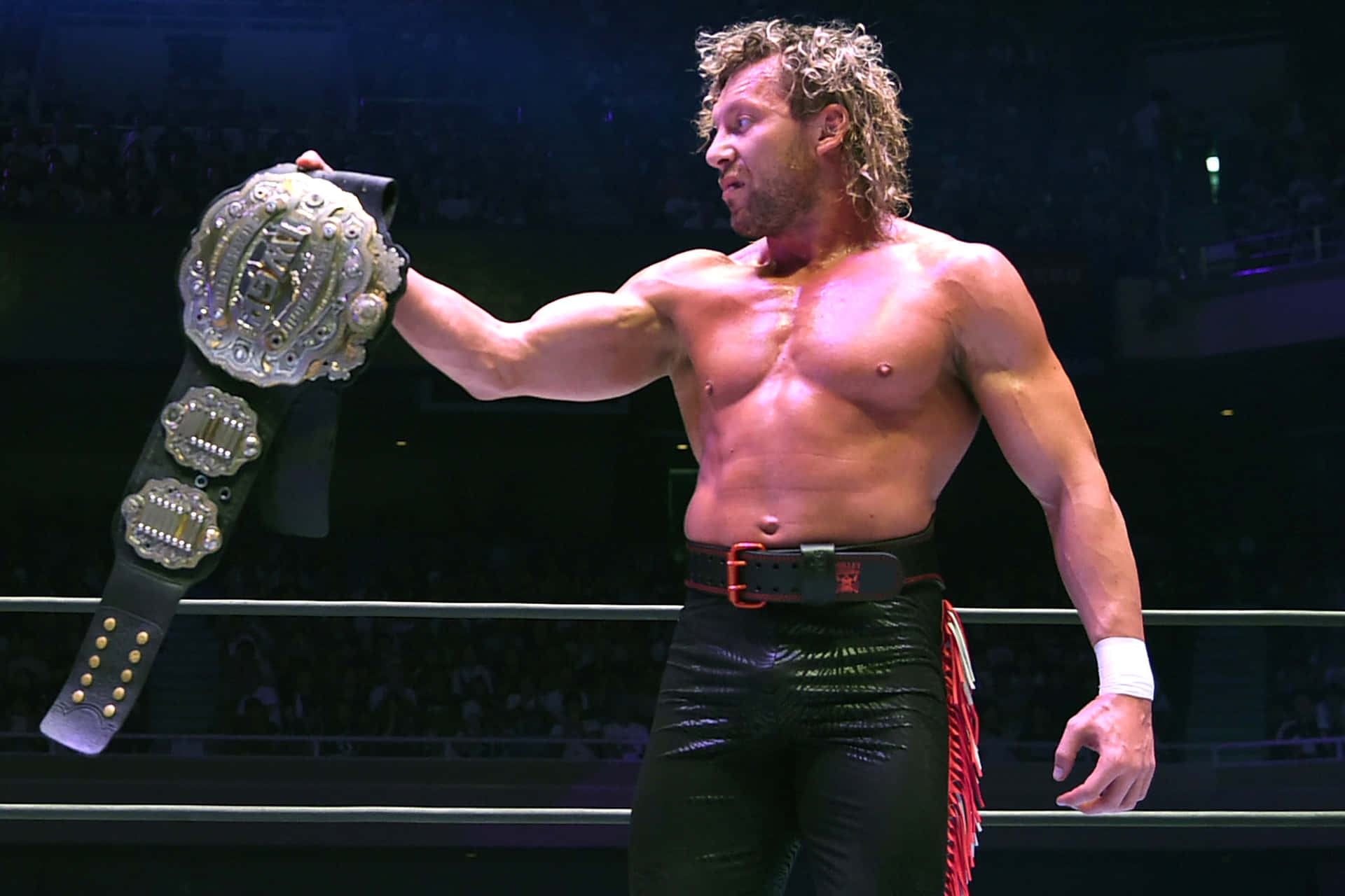 Kenny Omega Looking At His Championship Belt