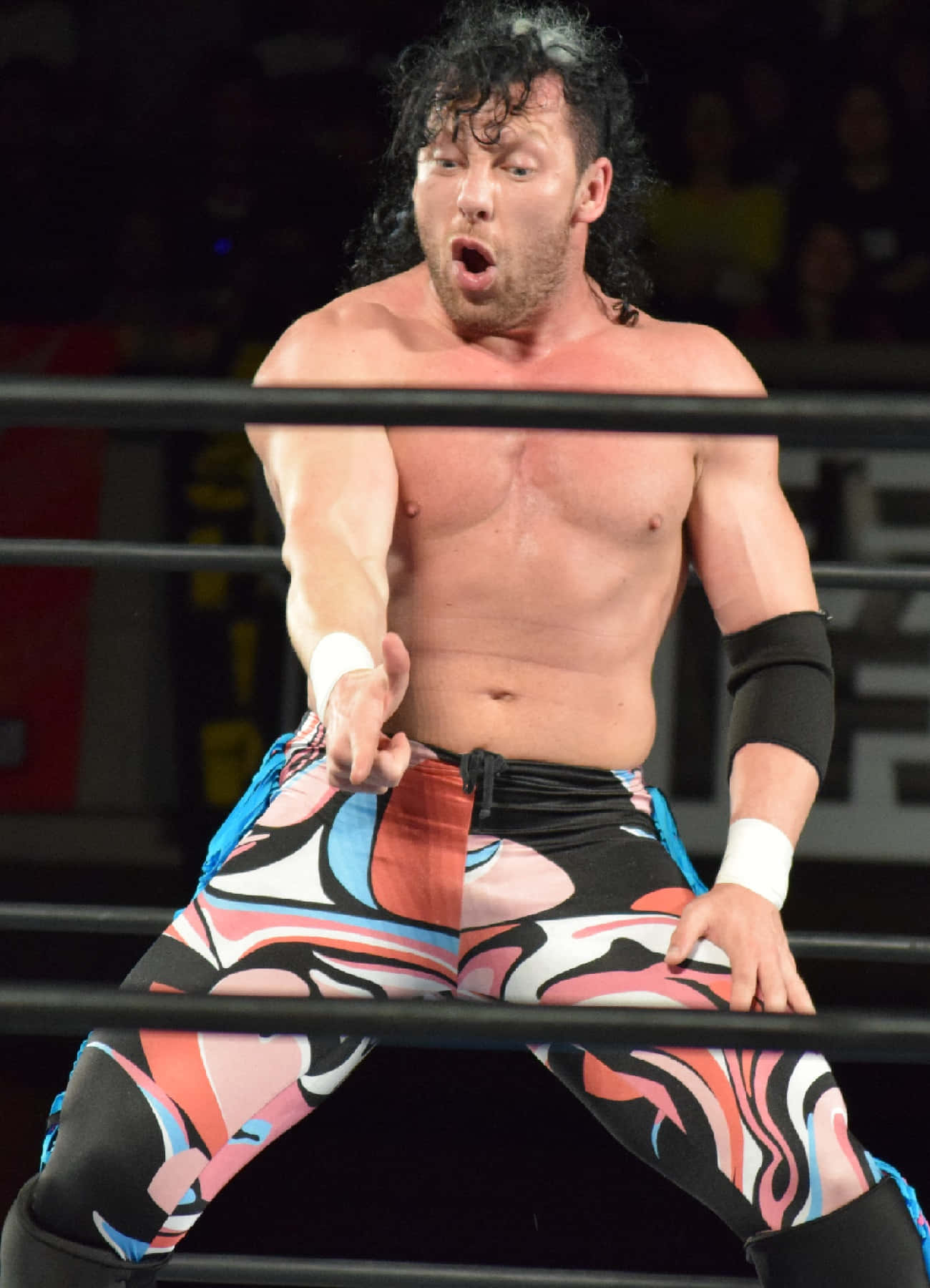 Kenny Omega Signature Pose In Japanese Wrestling Organization Background