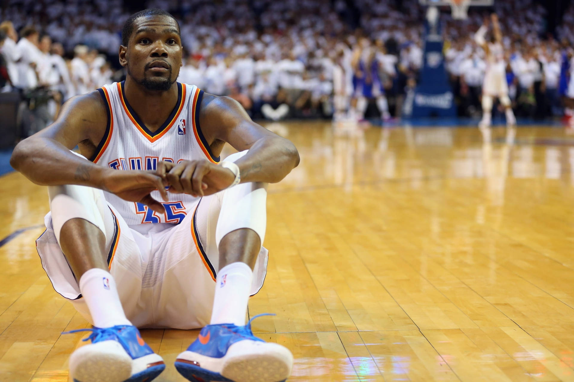 Kevin Durant Sitting On Basketball Court Background