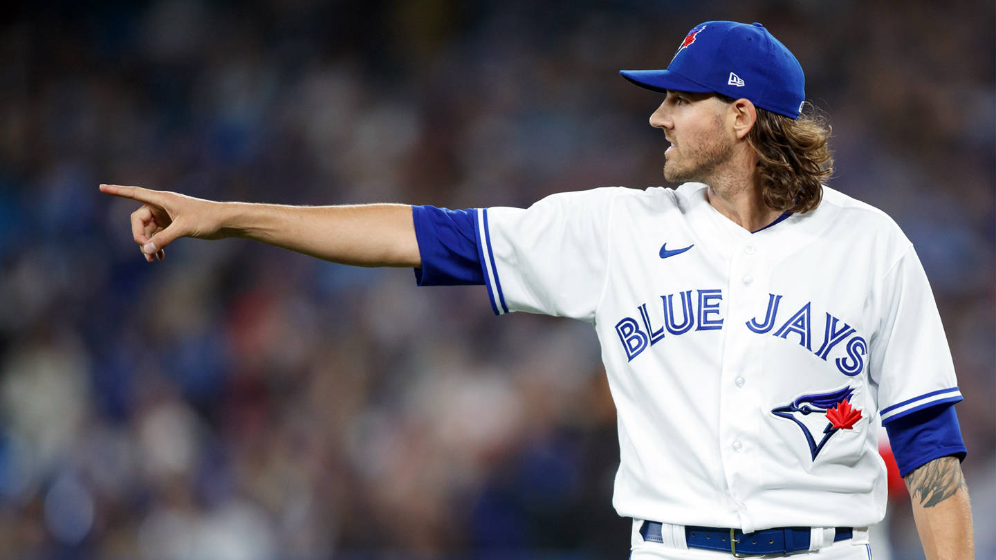 Kevin Gausman Wearing A White And Blue Jersey Background