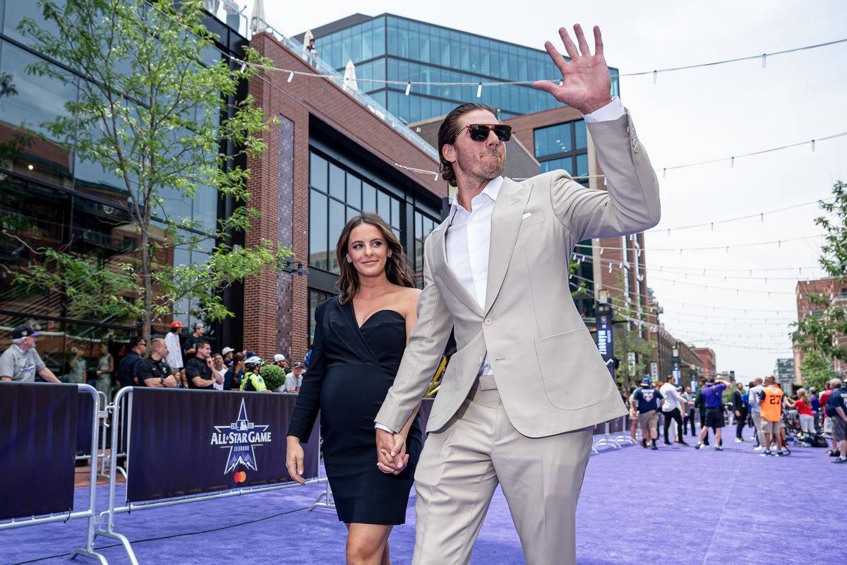 Kevin Gausman With His Wife On Purple Carpet Background