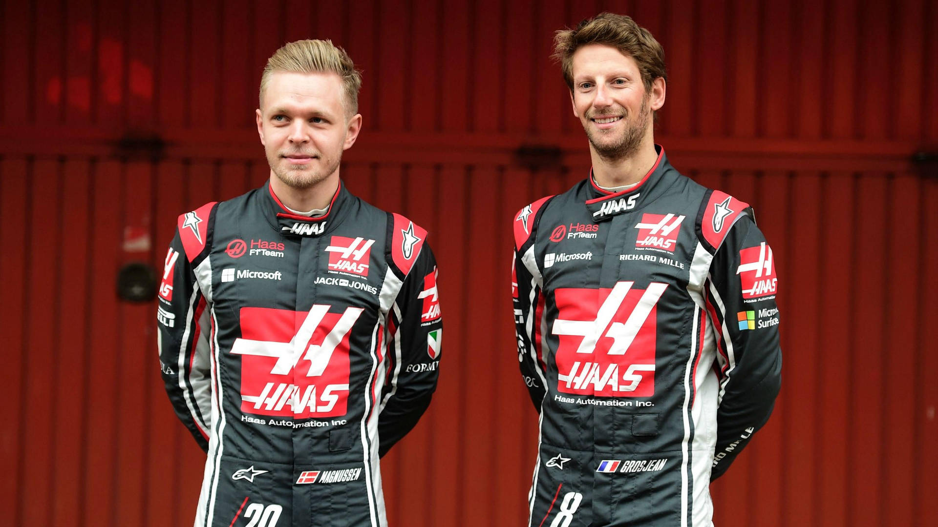 Kevin Magnussen And Grosjean Black Overalls Background