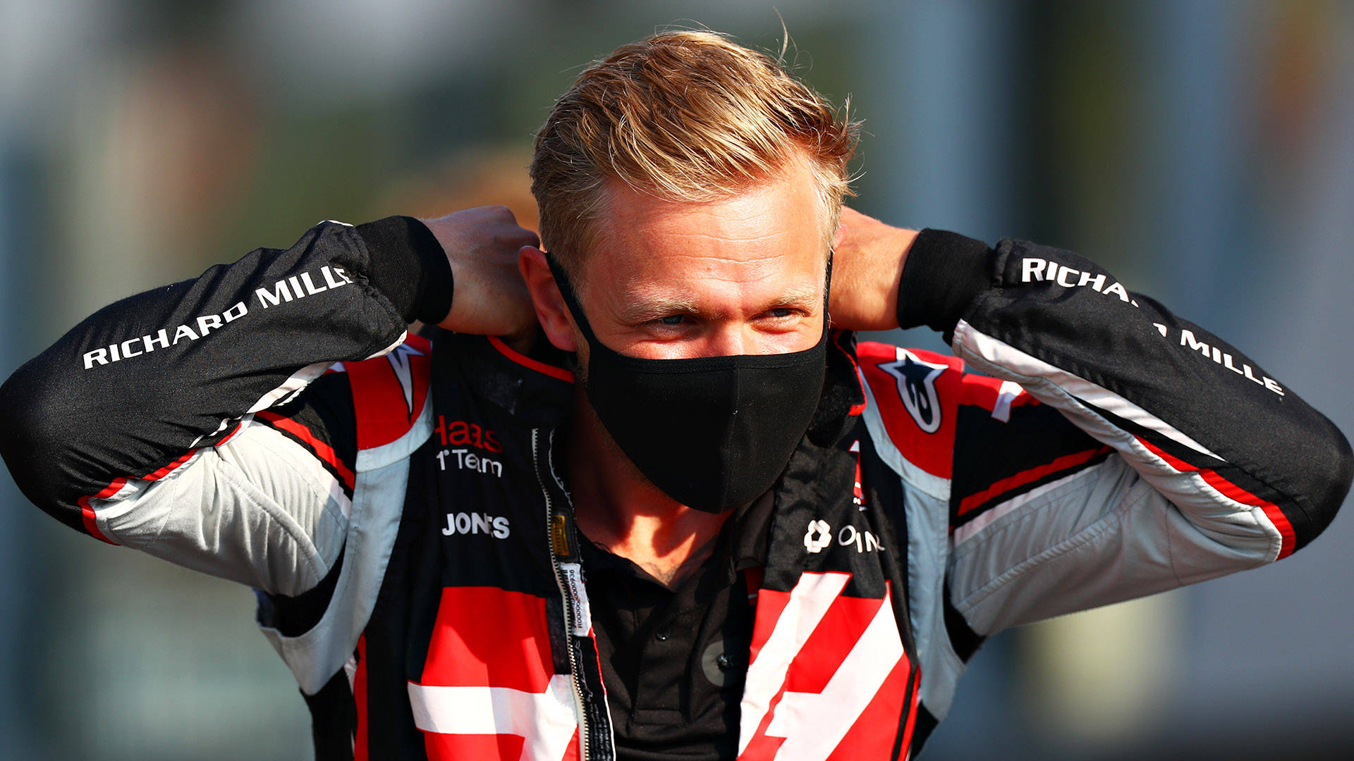 Kevin Magnussen Wearing A Mask Background