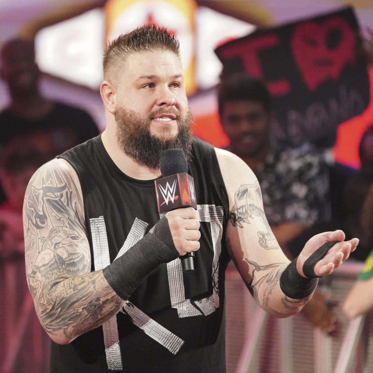 Kevin Owens Striking A Pose During A Live Event Background