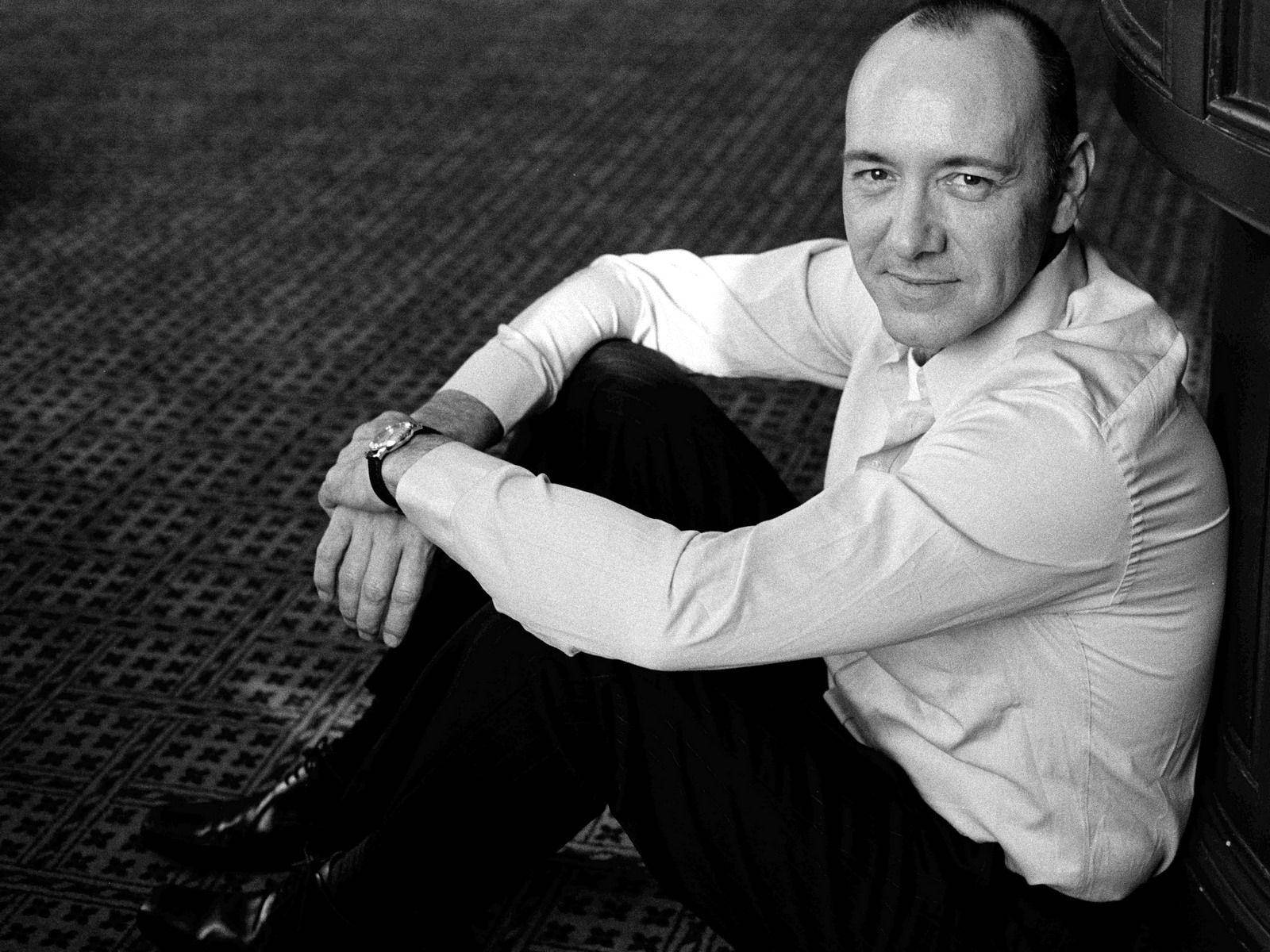 Kevin Spacey Contemplative On The Floor Background