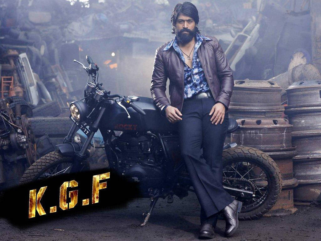 Kgf Rocky Bhai Leaning On Motorcycle Background