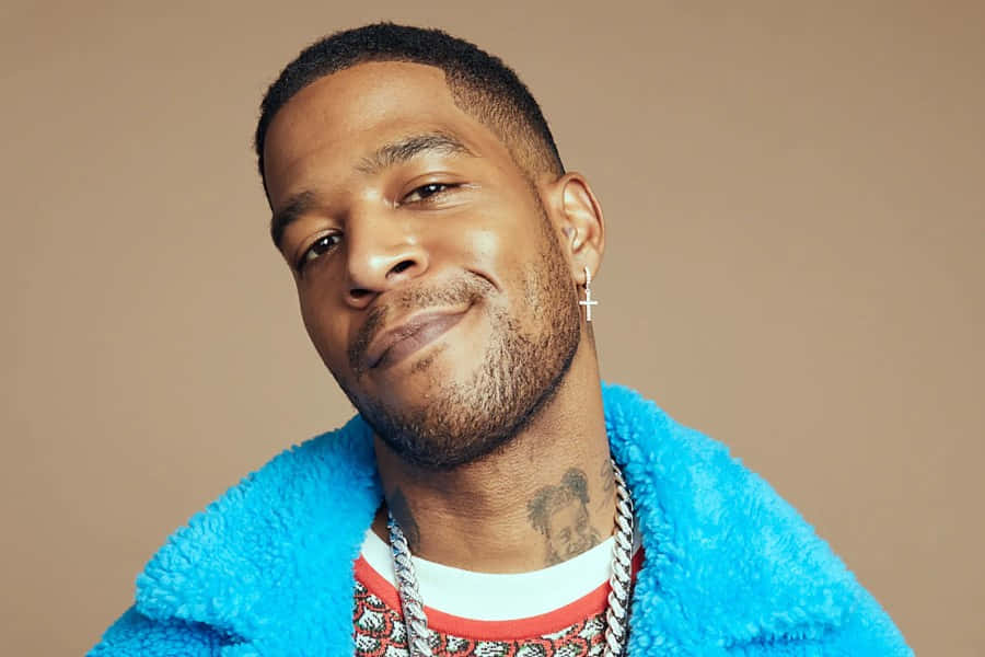 Kid Cudi Smilingin Blue Fur Coat Background