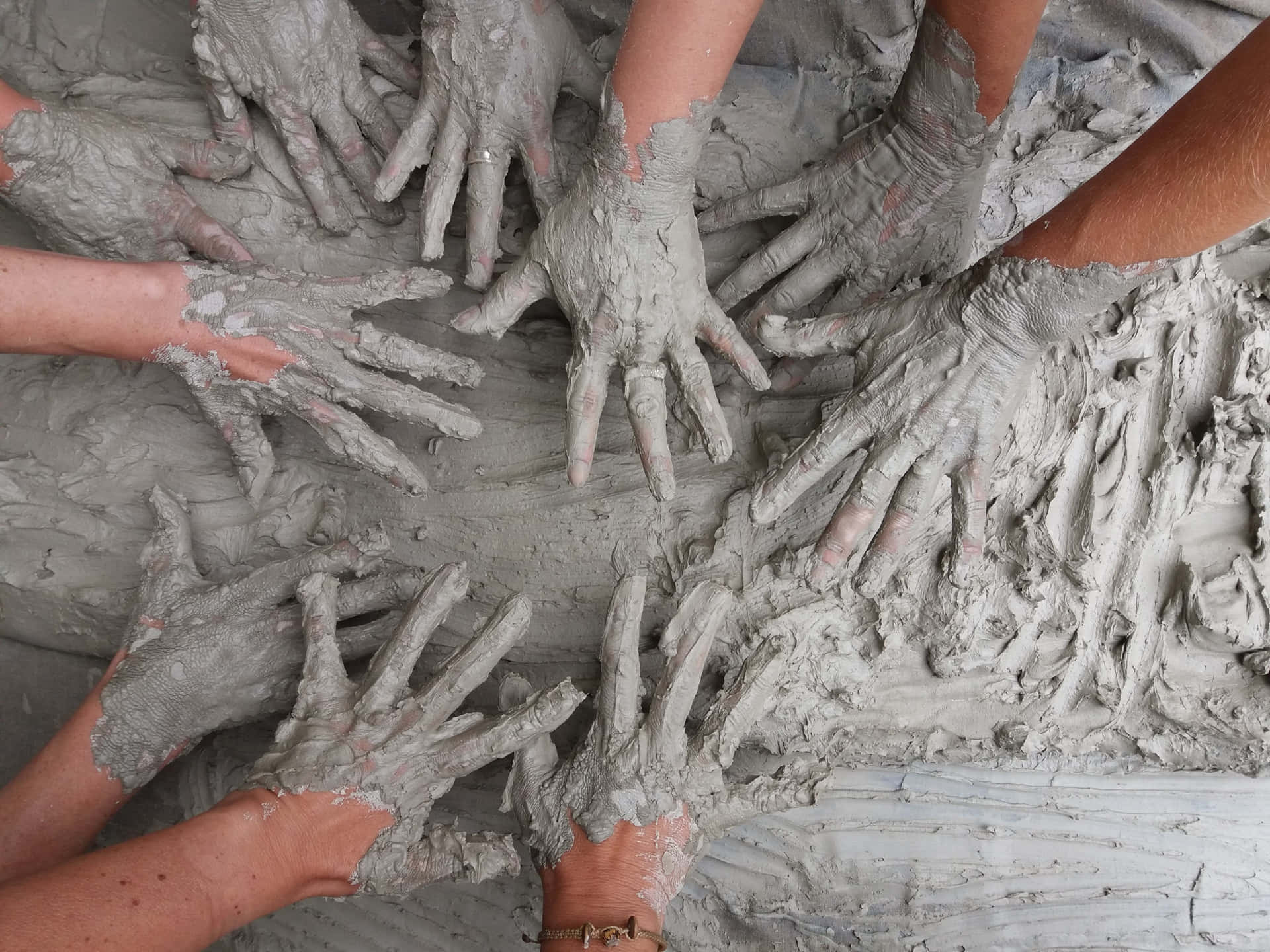 Kids Engaged In Pottery Making With Grey Mud Background