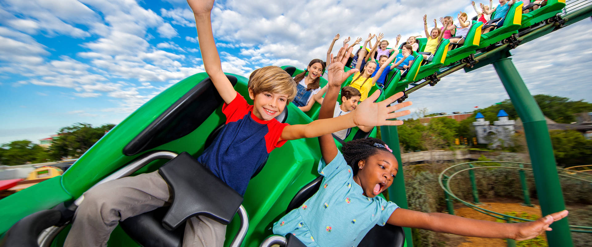 Kids Enjoying Rollercoaster At Legoland Background