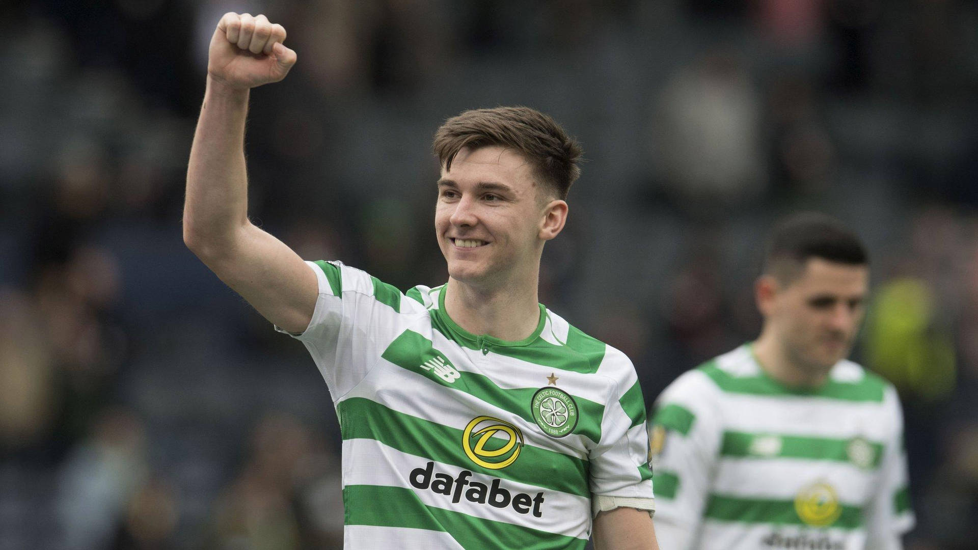 Kieran Tierney Celebrating Victory With Raised Fists Background