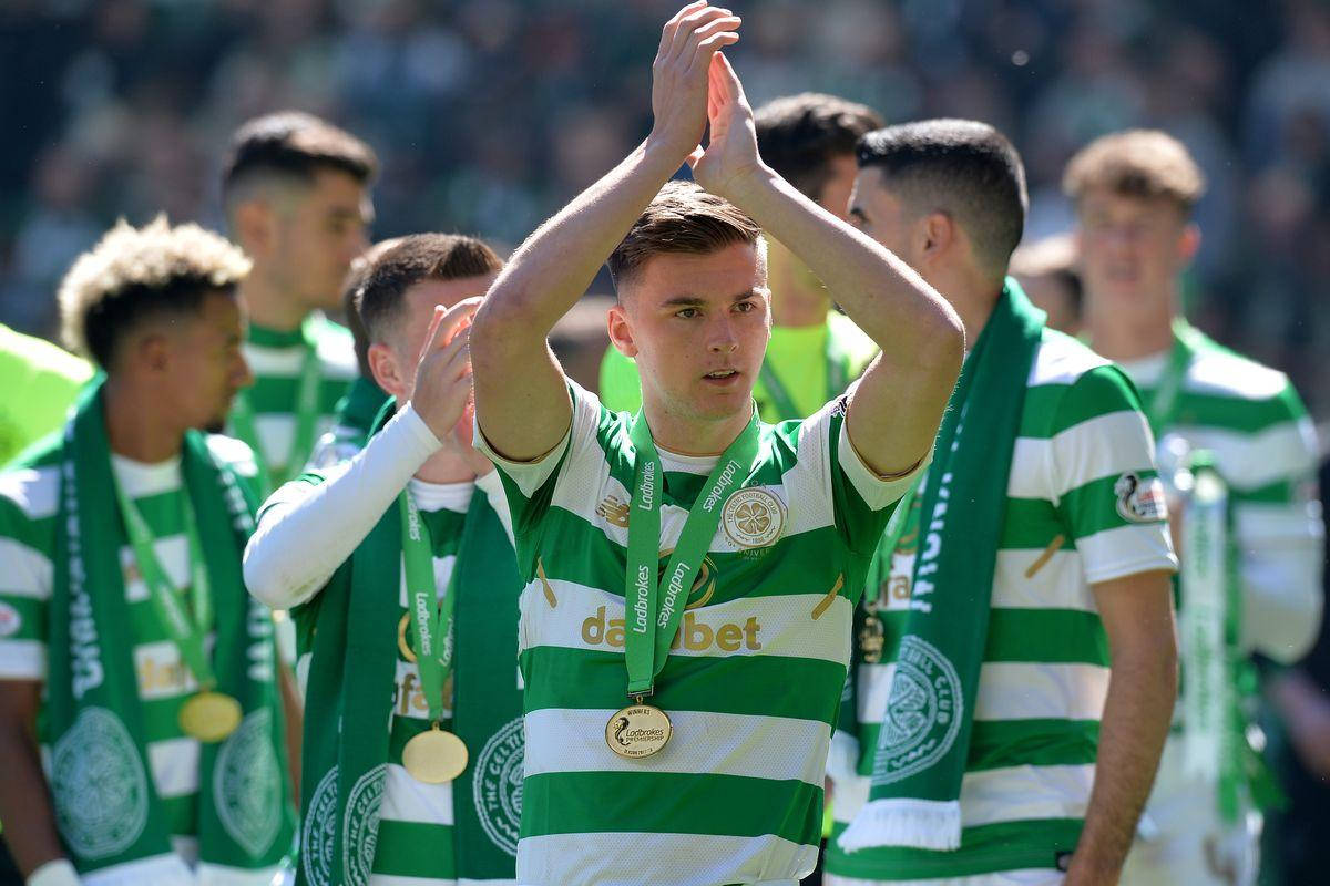 Kieran Tierney Celebrating Victory With Team And Medals Background