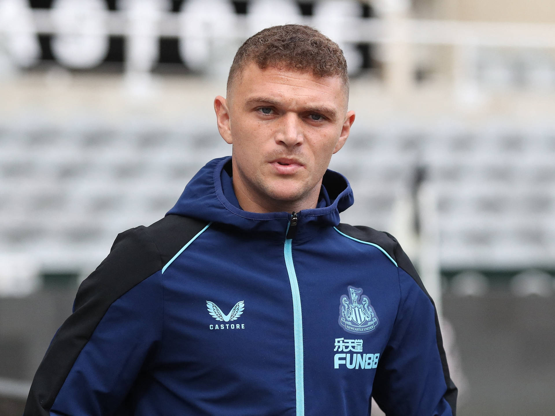 Kieran Trippier Posing In A Blue Windbreaker Background