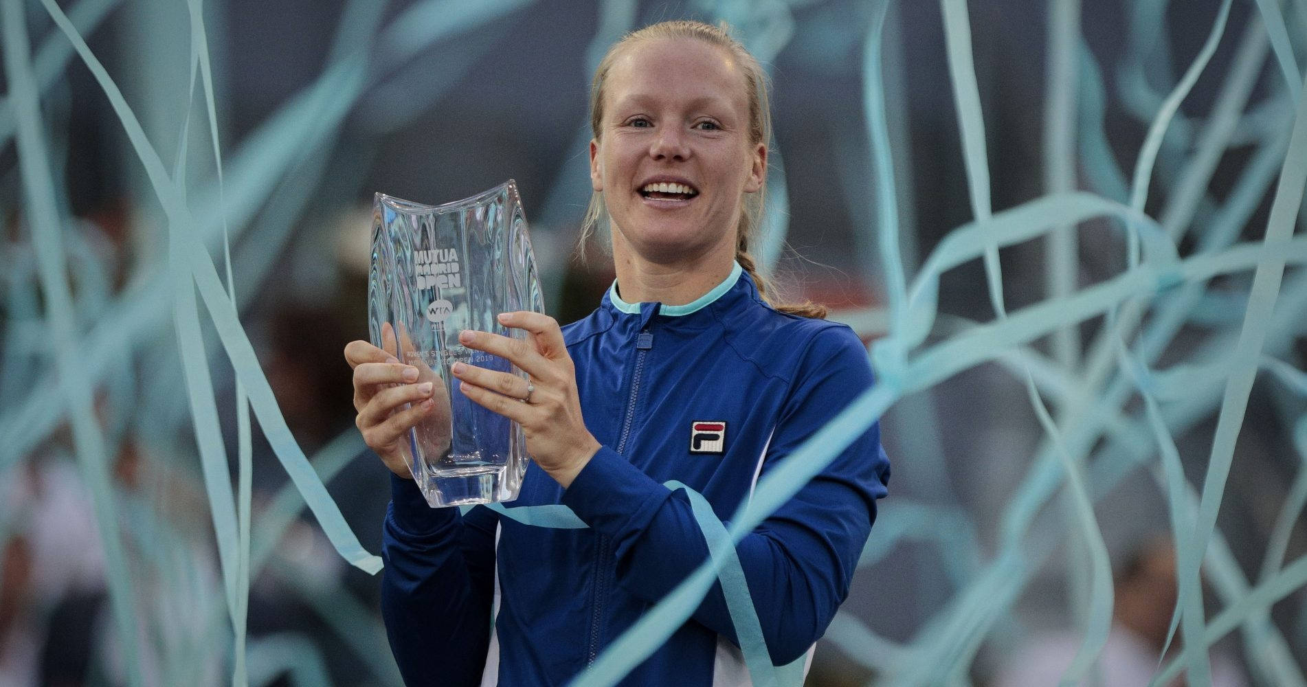 Kiki Bertens Celebrating With Blue Streamers Background