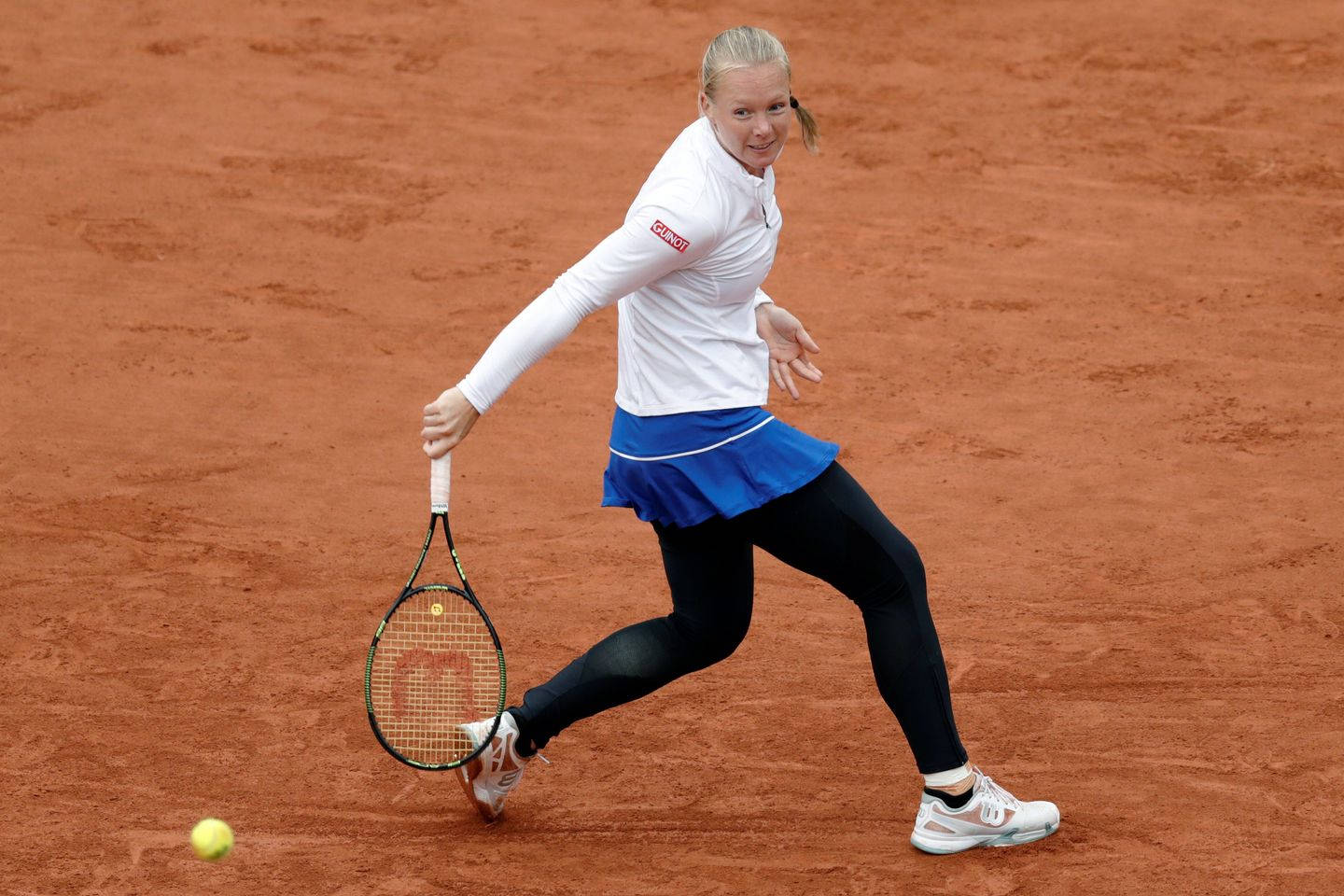 Kiki Bertens Demonstrating Her Power And Skill On A Clay Court Background