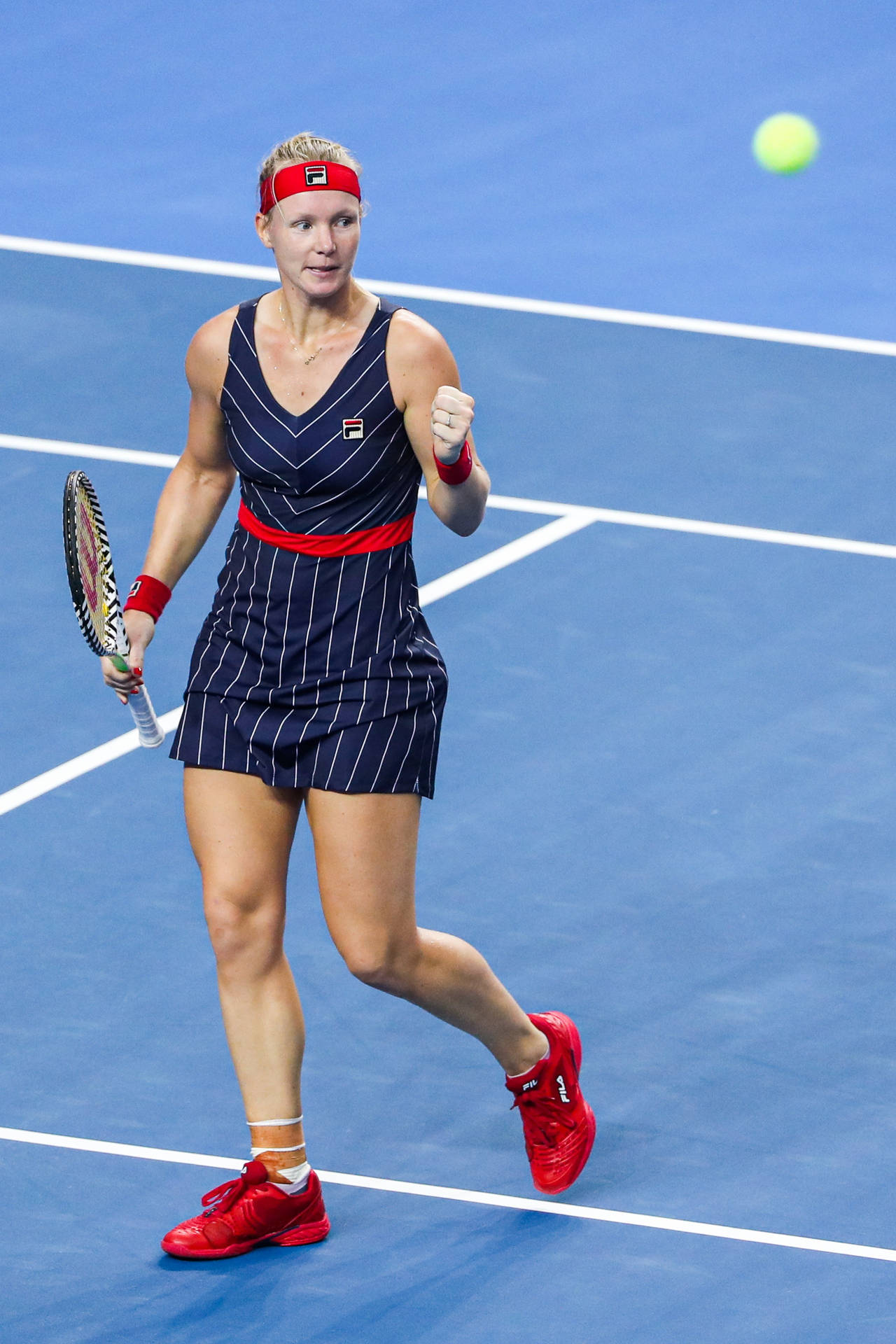 Kiki Bertens Sporting A Chic Striped Fila Dress On The Tennis Court Background