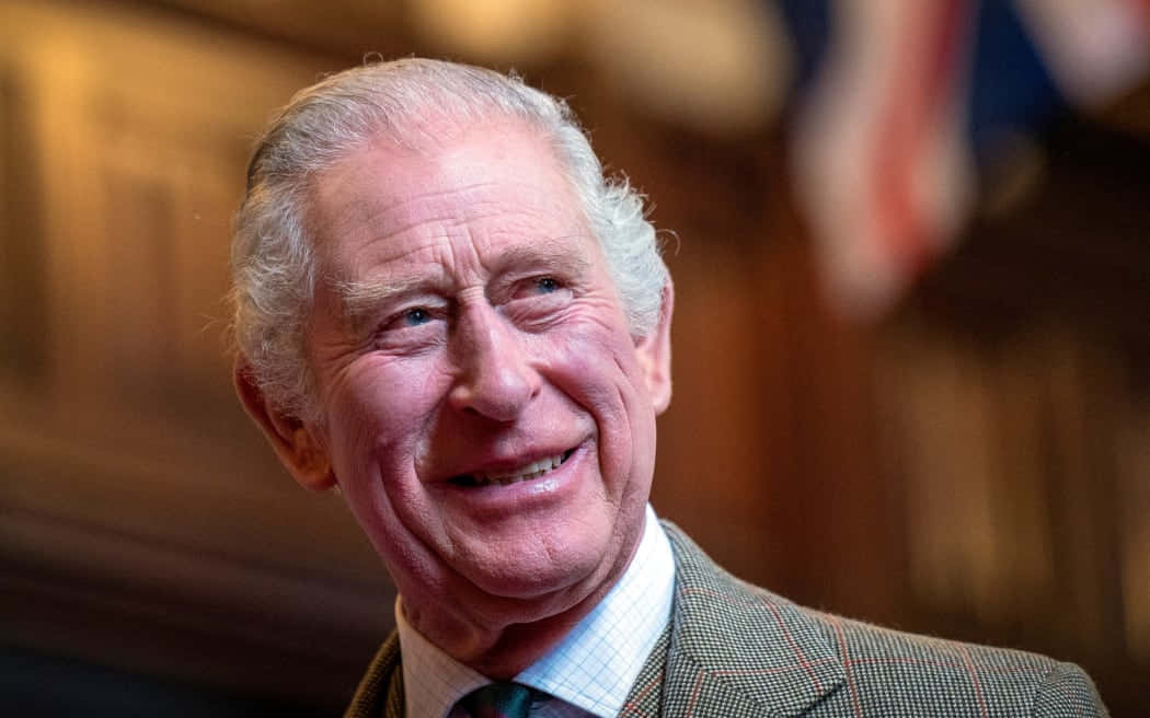 King Charles Iii Smiling In Parliament Background
