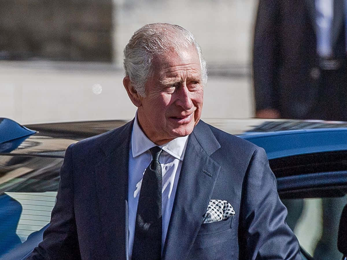 King Charles Iii Walking From Car Background