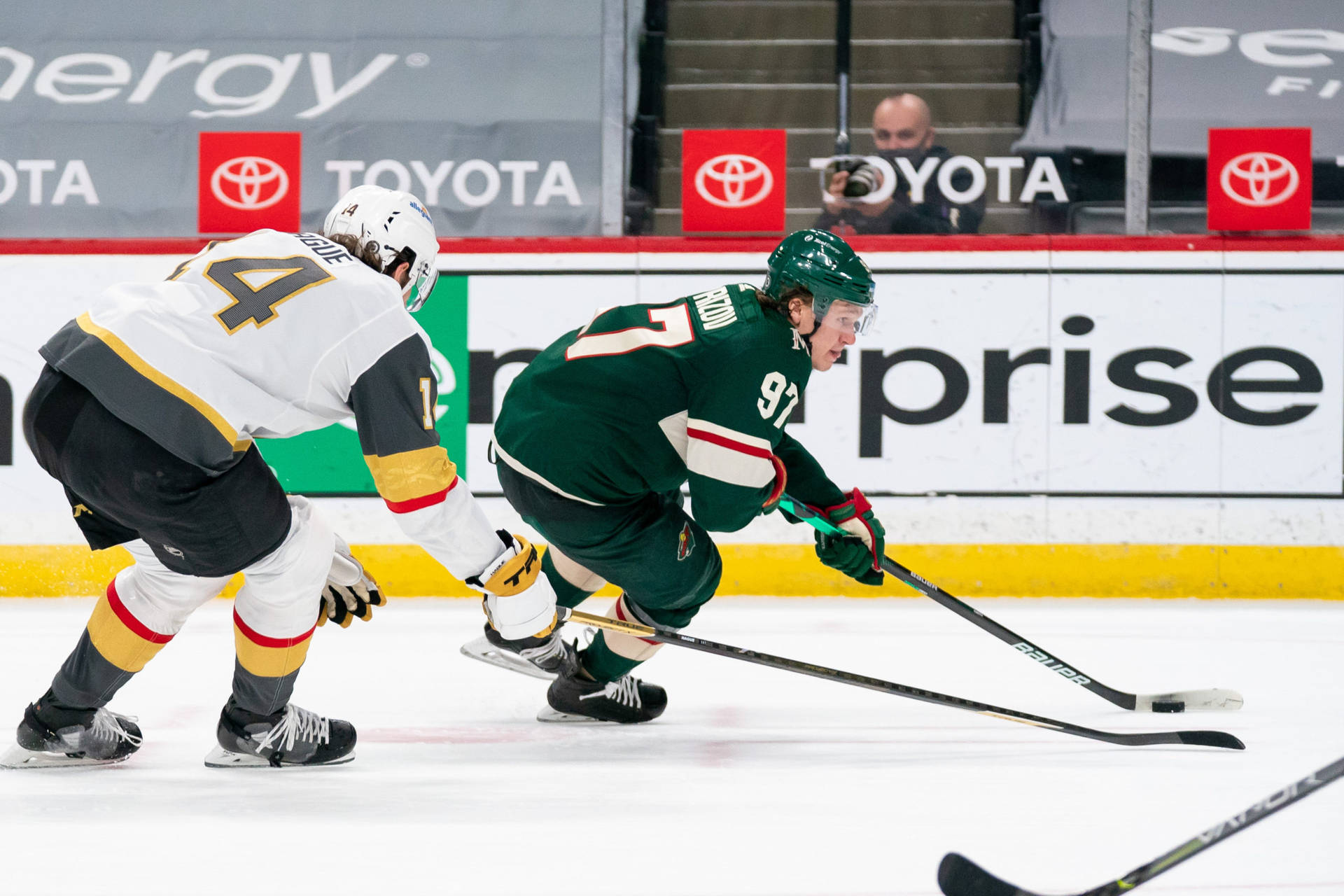 Kirill Kaprizov In Action, Skillfully Fighting For A Puck Amidst A Hockey Game