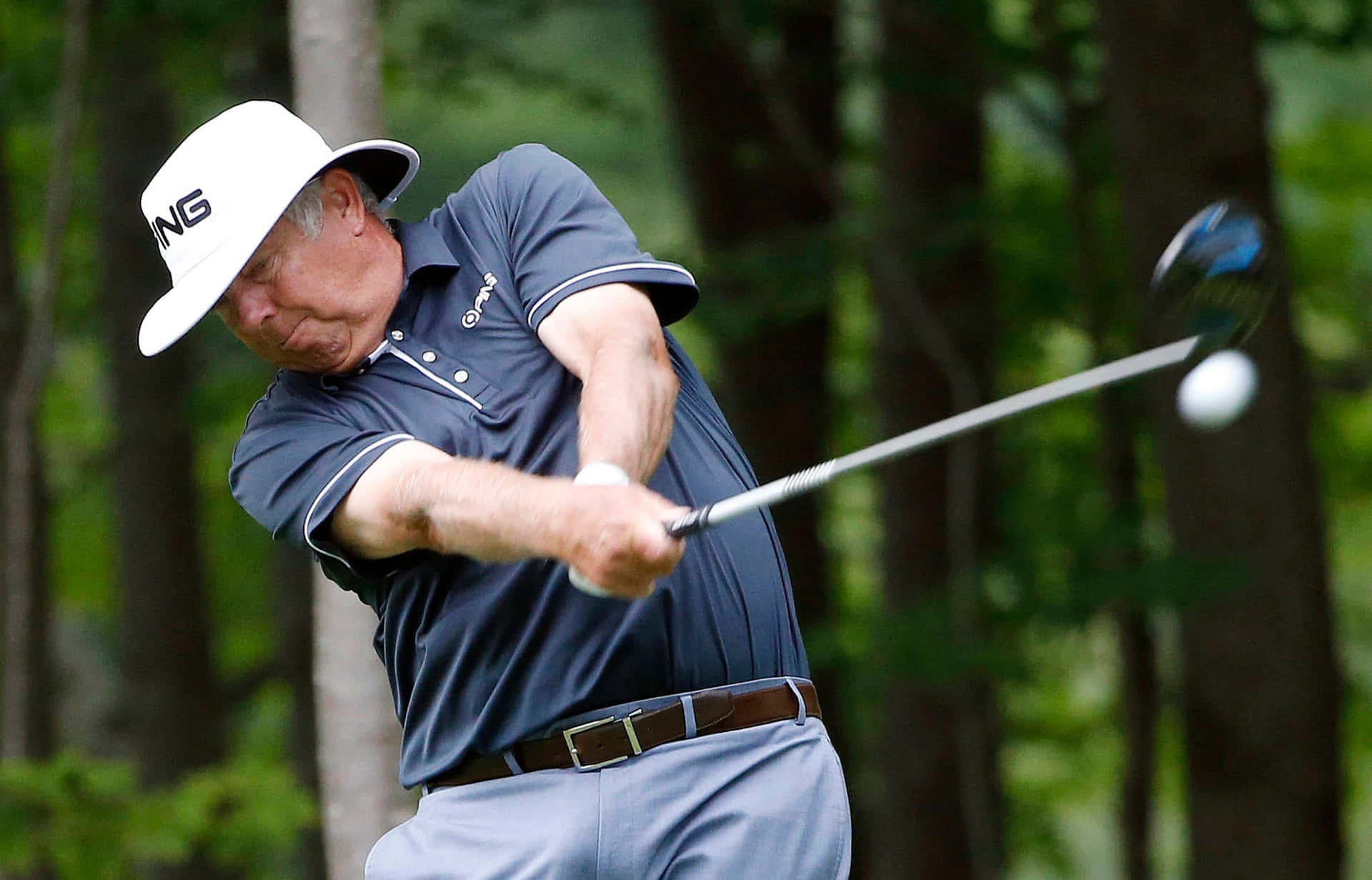 Kirk Triplett Hitting The Golf Ball Background