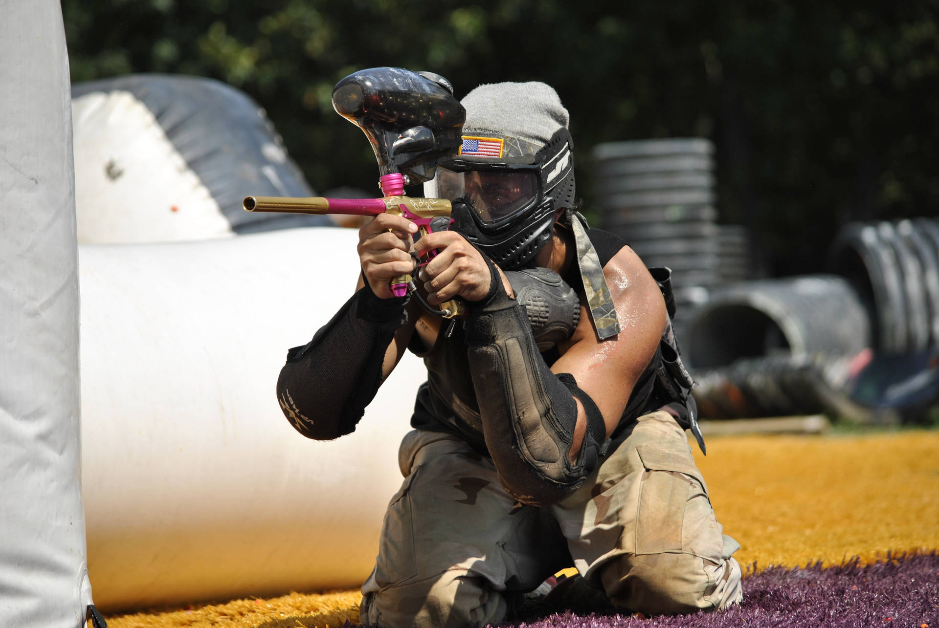 Kneeling Paintball Player Taking Aim Background