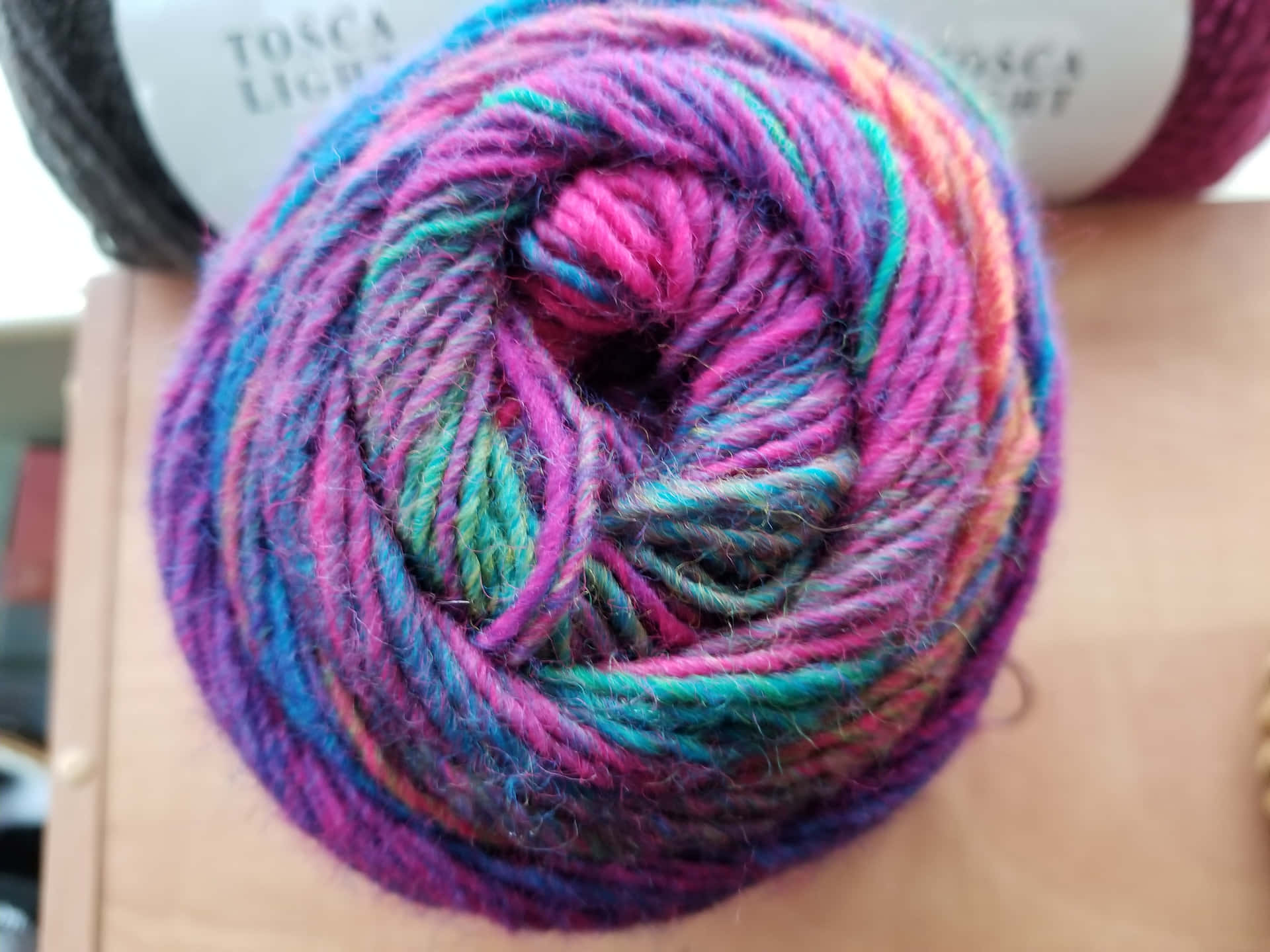 Knitting Dreams: A Close-up Image Of A Ball Of Yarn Background