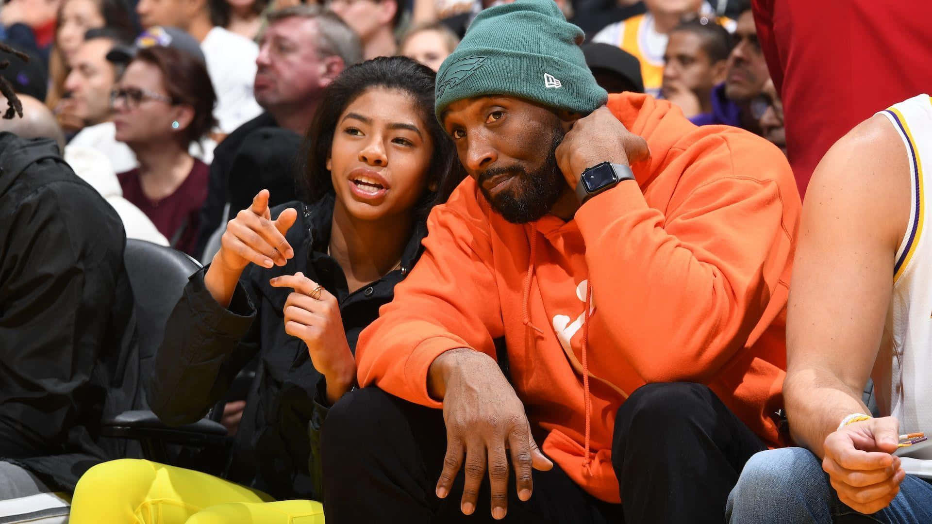 Kobe Bryant And His Daughter Gigi At A Basketball Game Background