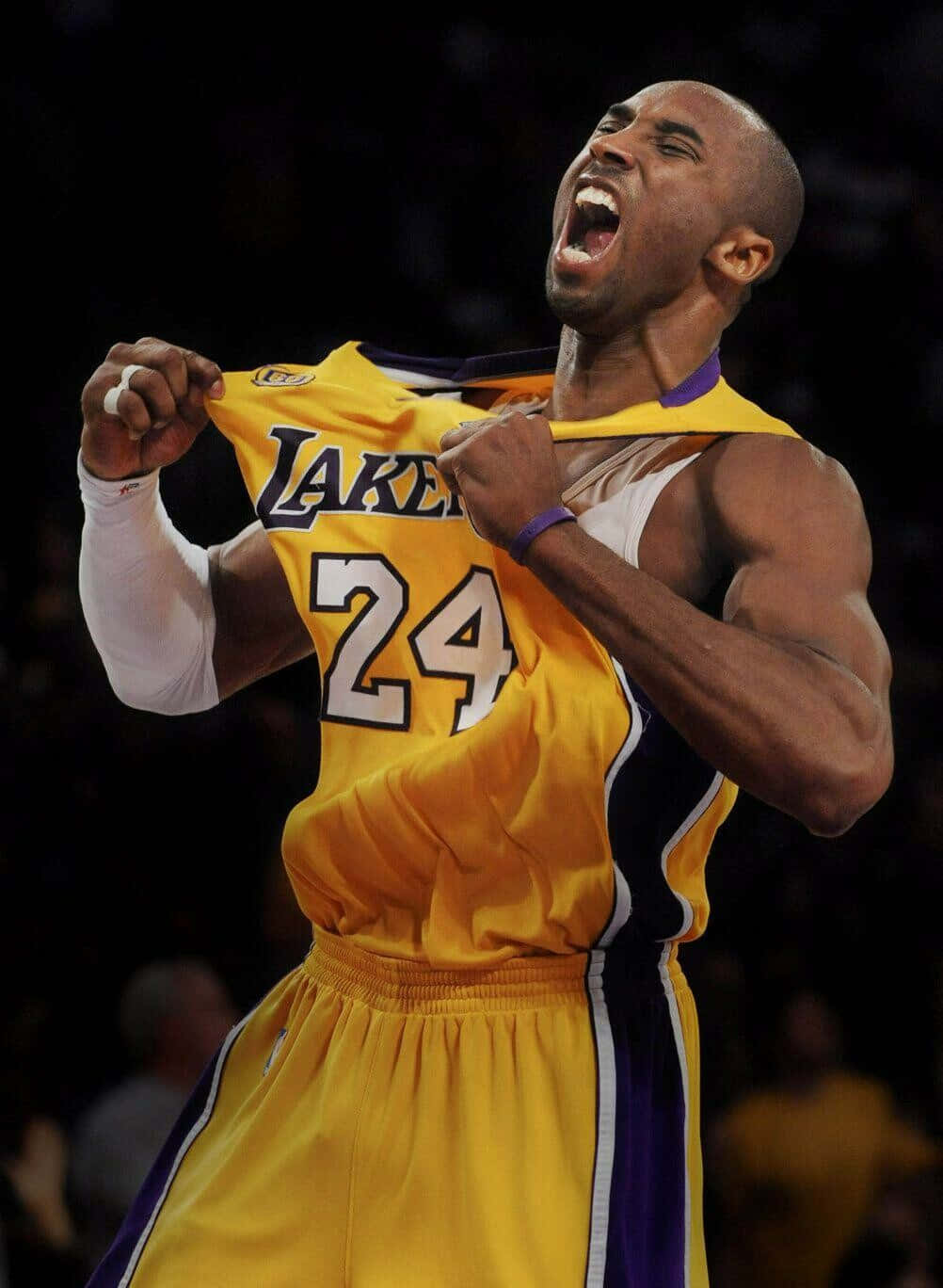 Kobe Bryant Basketball Showing Off Lakers Jersey Background