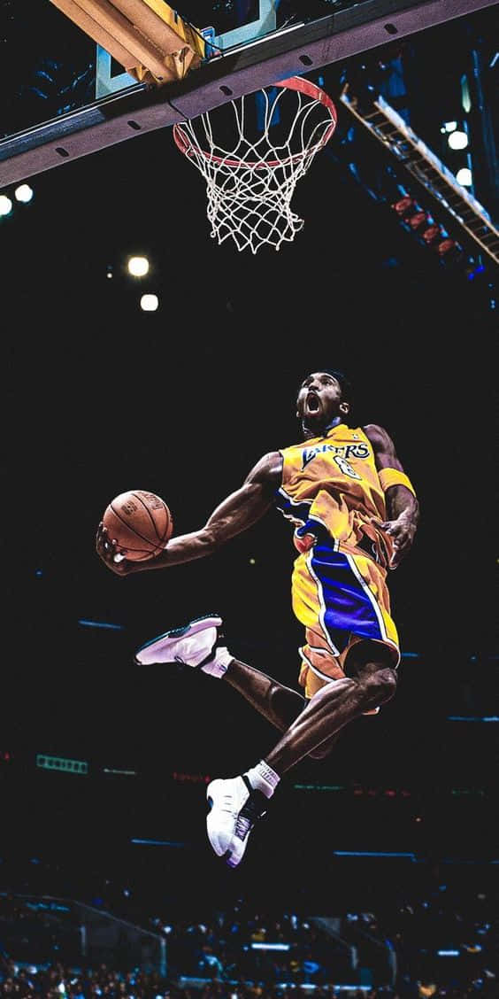 Kobe Bryant Flying Through The Air With Fierce Determination Background