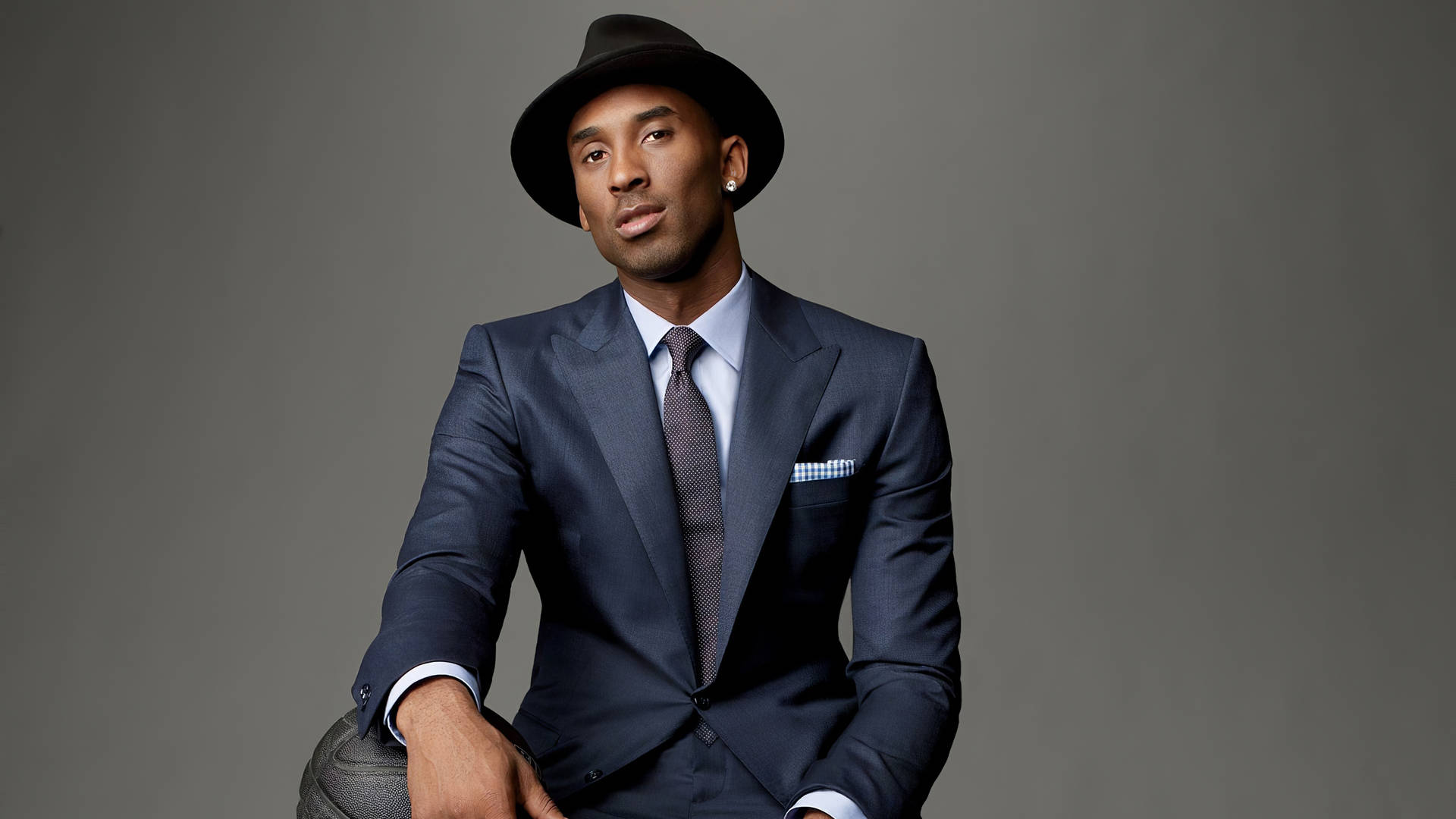 Kobe Bryant Is All Smiles In A Suit Background