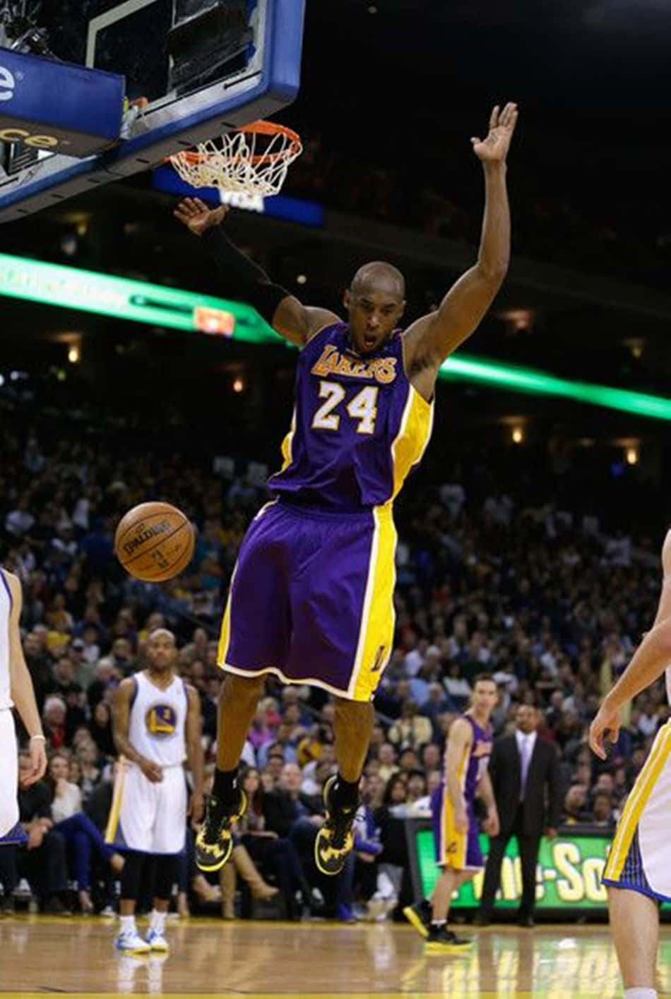 Kobe Bryant Putting On An Impressive Performance As He Soars Through The Air For An Emphatic Dunk. Background