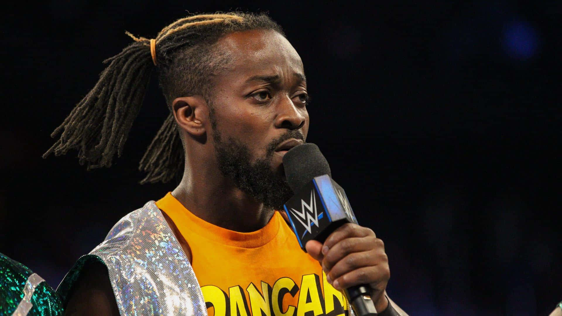 Kofi Kingston Holding A Microphone