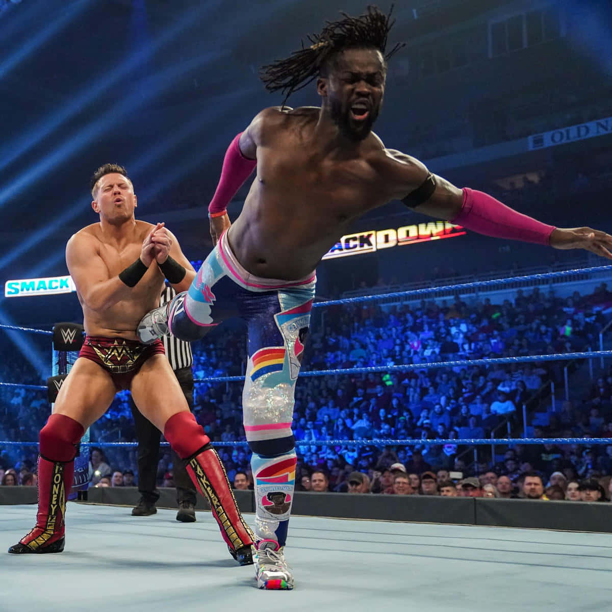 Kofi Kingston In Action Against The Miz Background