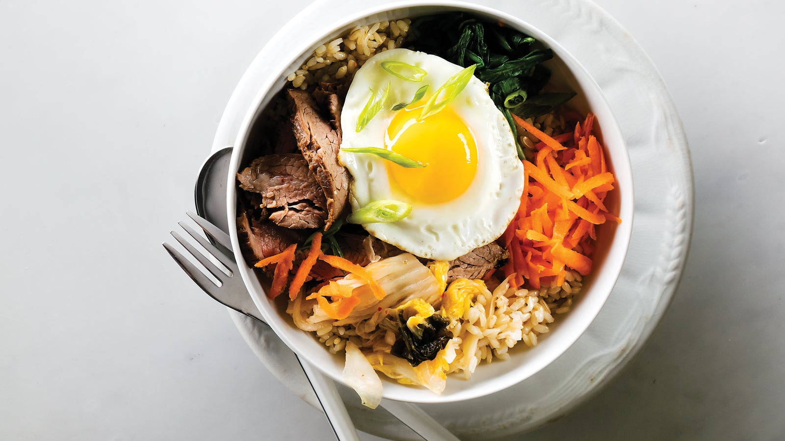 Korean Bibimbap With White Dishes