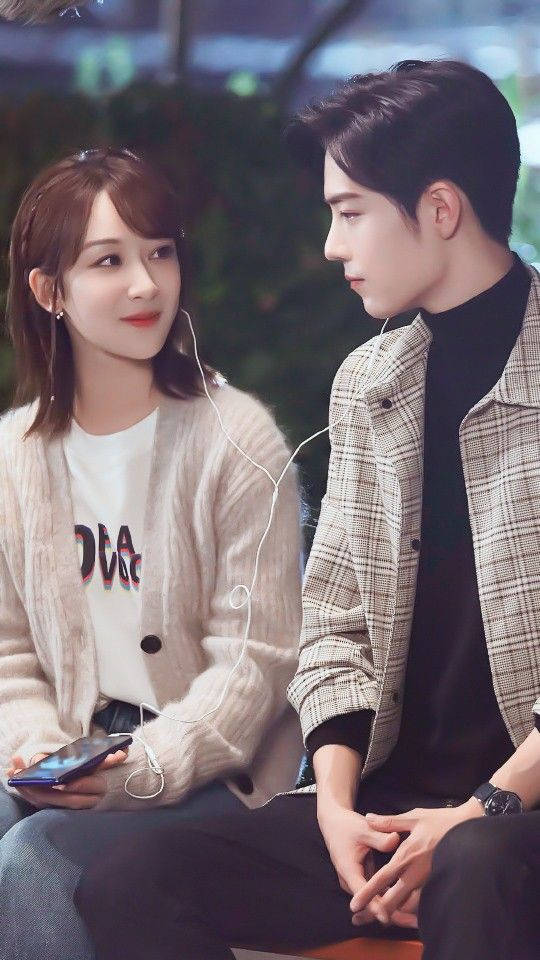 Korean Couple Sharing Earphones Background