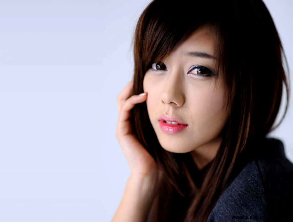 Korean Girl Showing Charm With A Hand Gesture Background