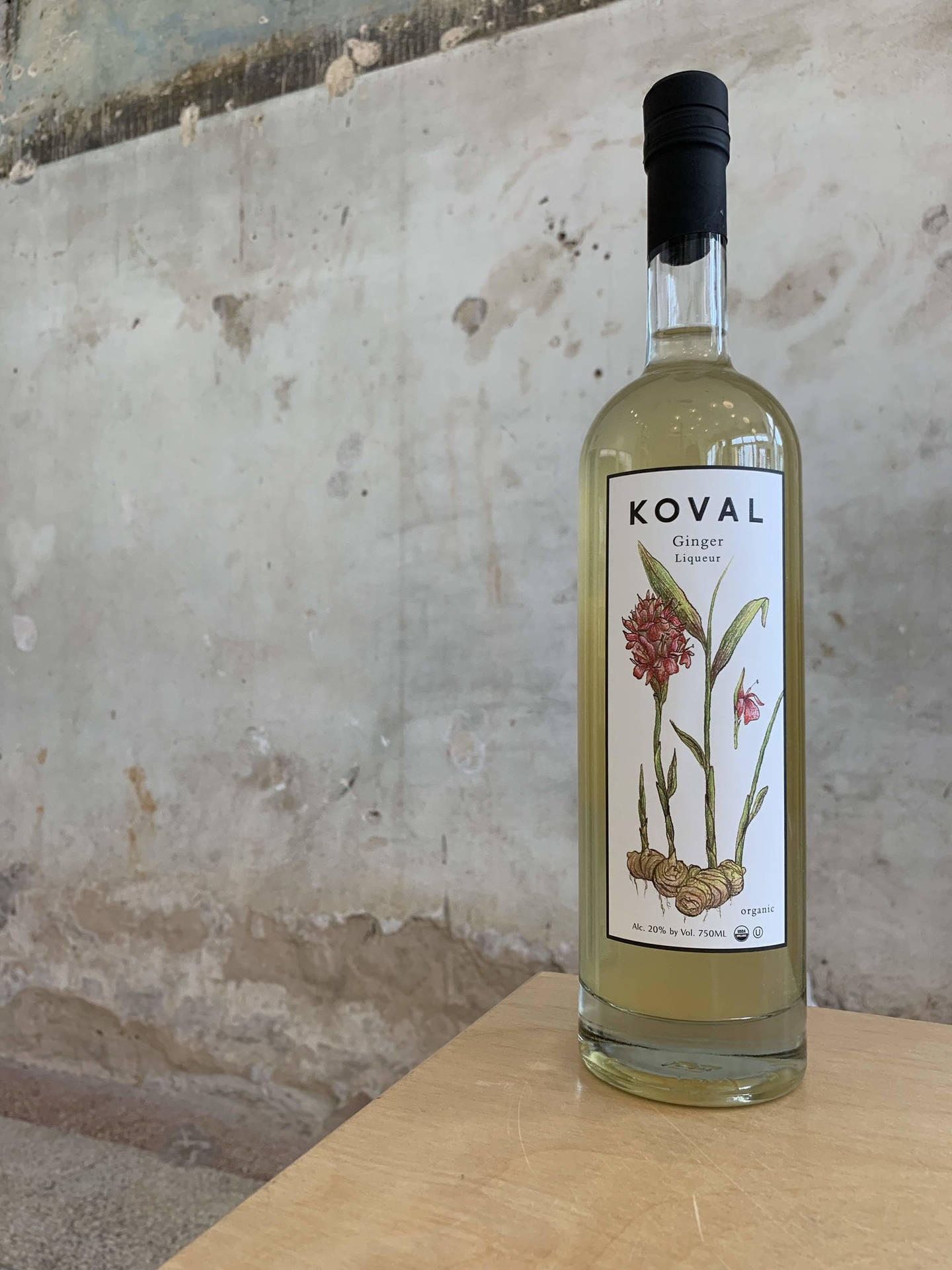 Koval Ginger Liqueur At The Table Background