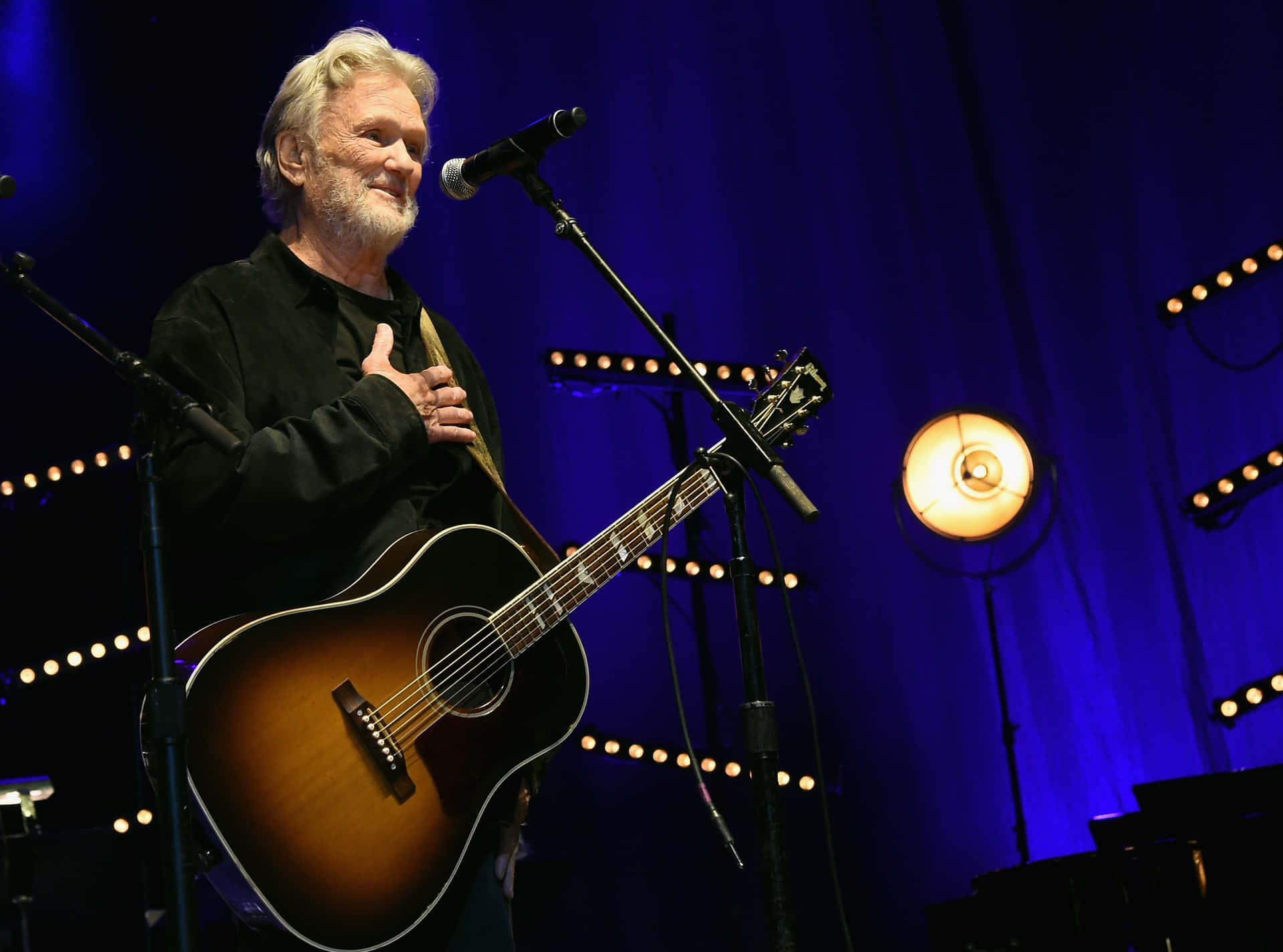 Kris Kristofferson On Stage With Guitar Background