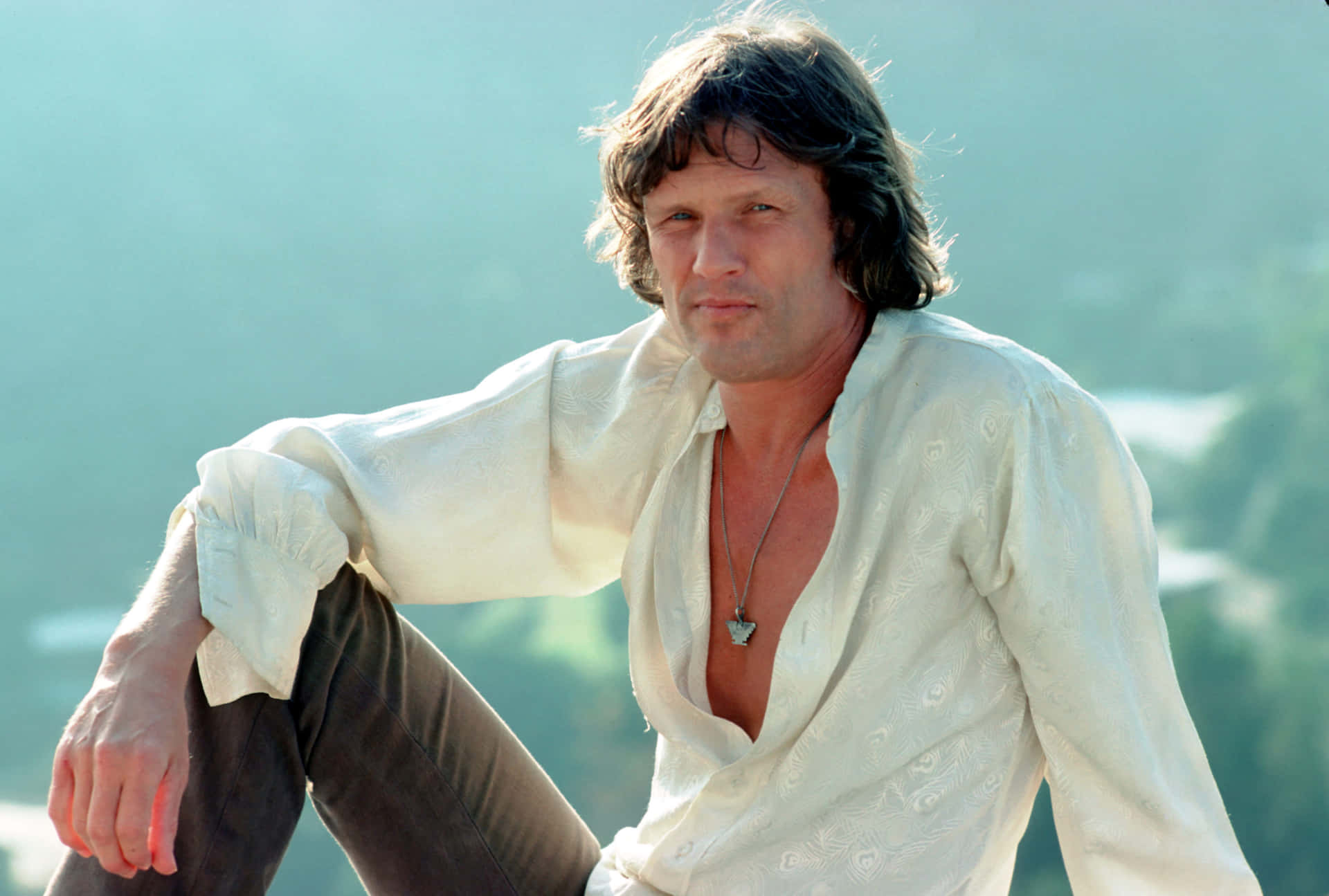 Kris Kristofferson Relaxed Pose Outdoors Background