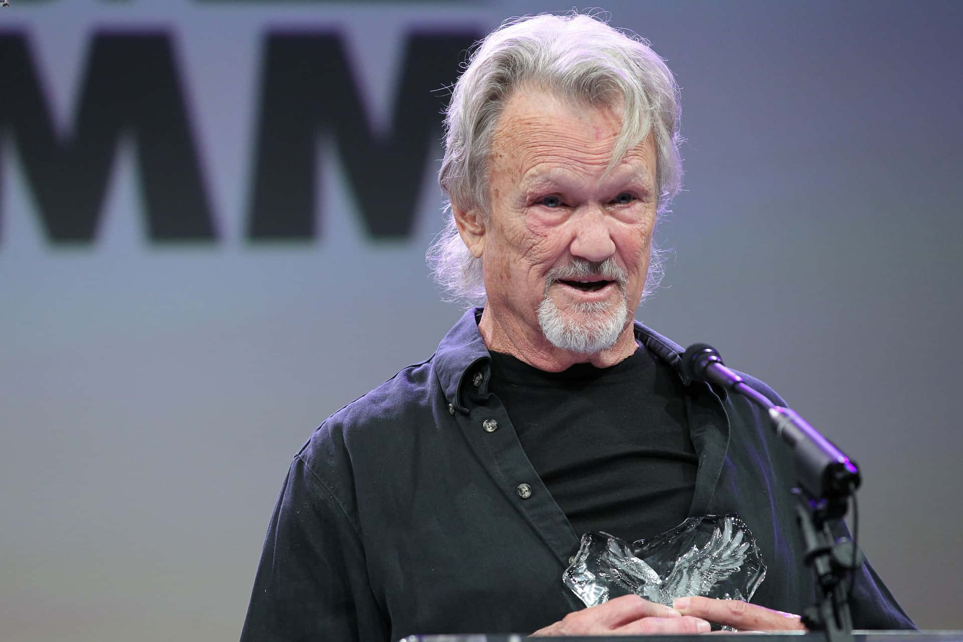 Kris Kristofferson Speakingat Event Background