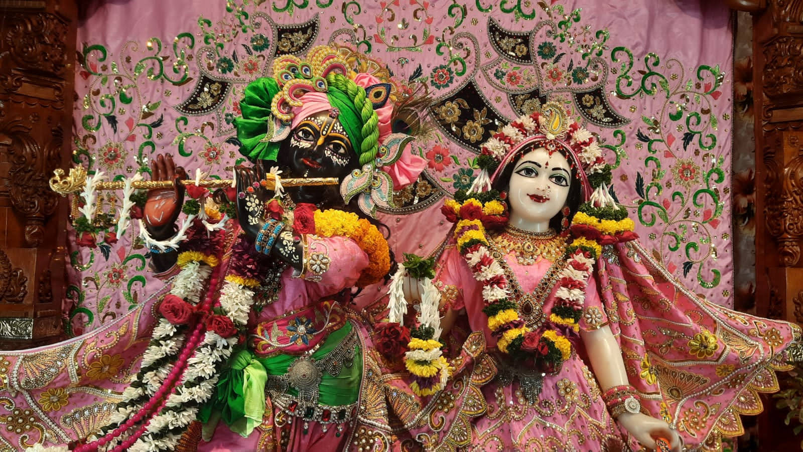 Krishna And Radha In Iskcon Temple Wearing Pink Background