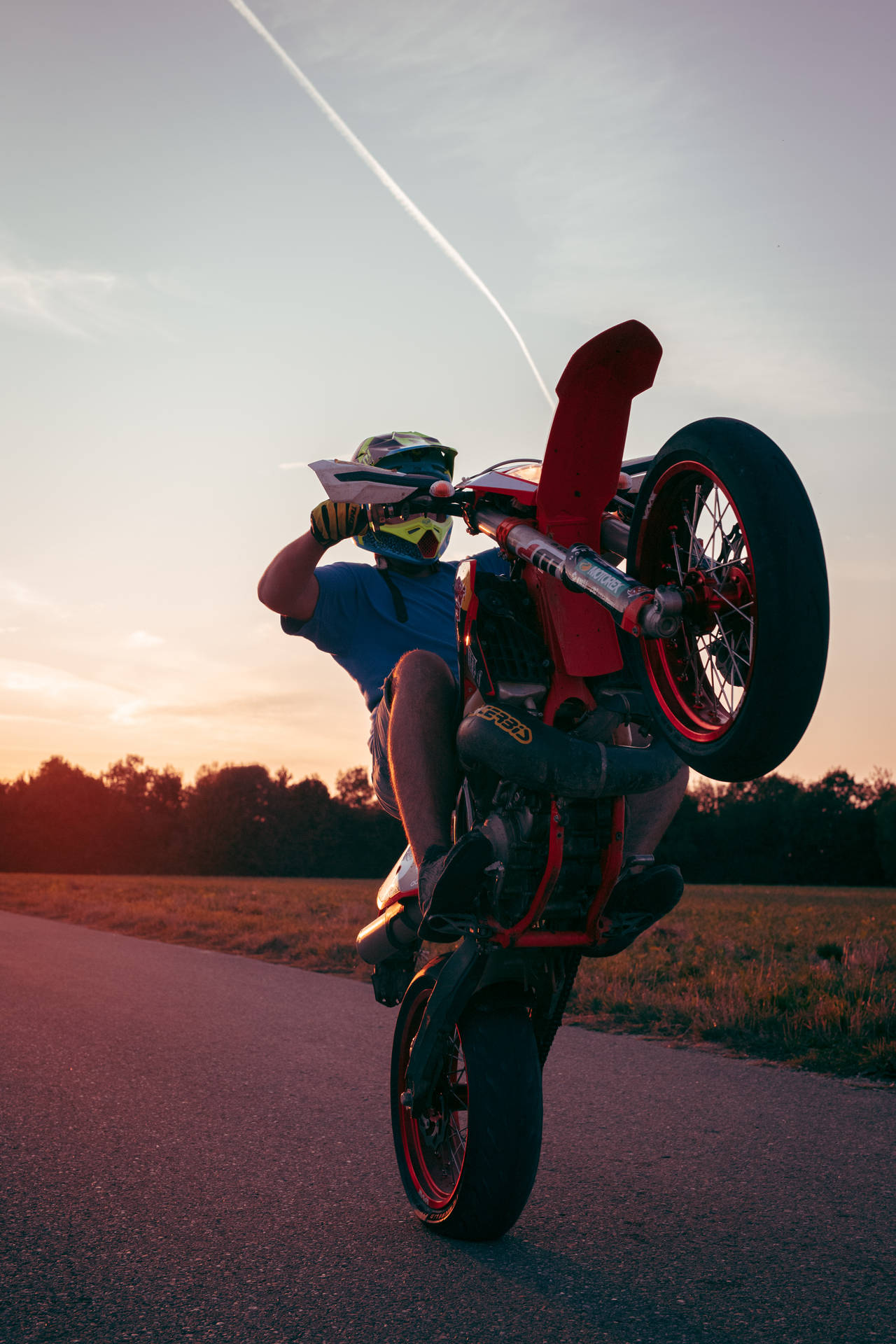 Ktm Biker During Wheelie Background